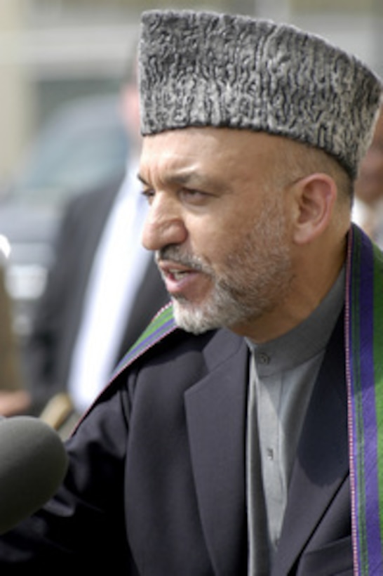 Afghan President Hamid Kazai speaks to reporters during a joint media availability with Secretary of Defense Donald H. Rumsfeld at the Pentagon on June 14, 2004. 