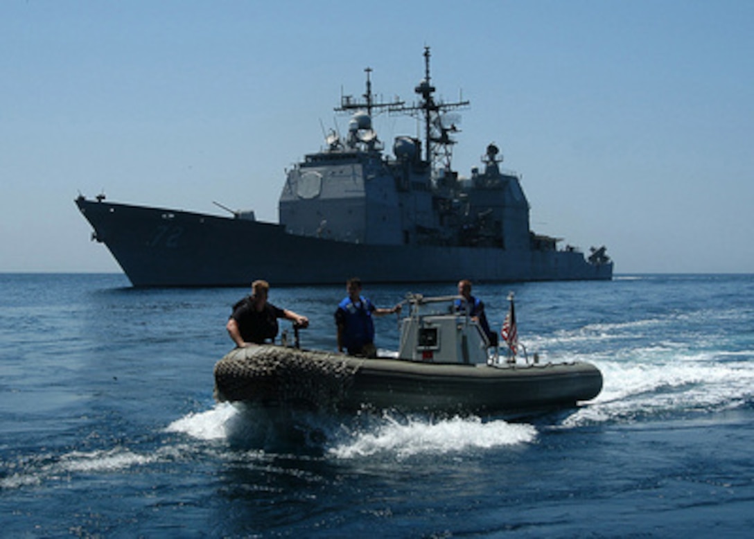 Crew members from USS Vella Gulf (CG 72) operate a Rigid Hull Inflatable Boat, more commonly called a RHIB, to pick up sailors and mail for transport from USS George Washington (CVN 73) on June 7, 2004. The Norfolk, Va., based ships are on a scheduled deployment in the Persian Gulf supporting Operation Iraqi Freedom. 