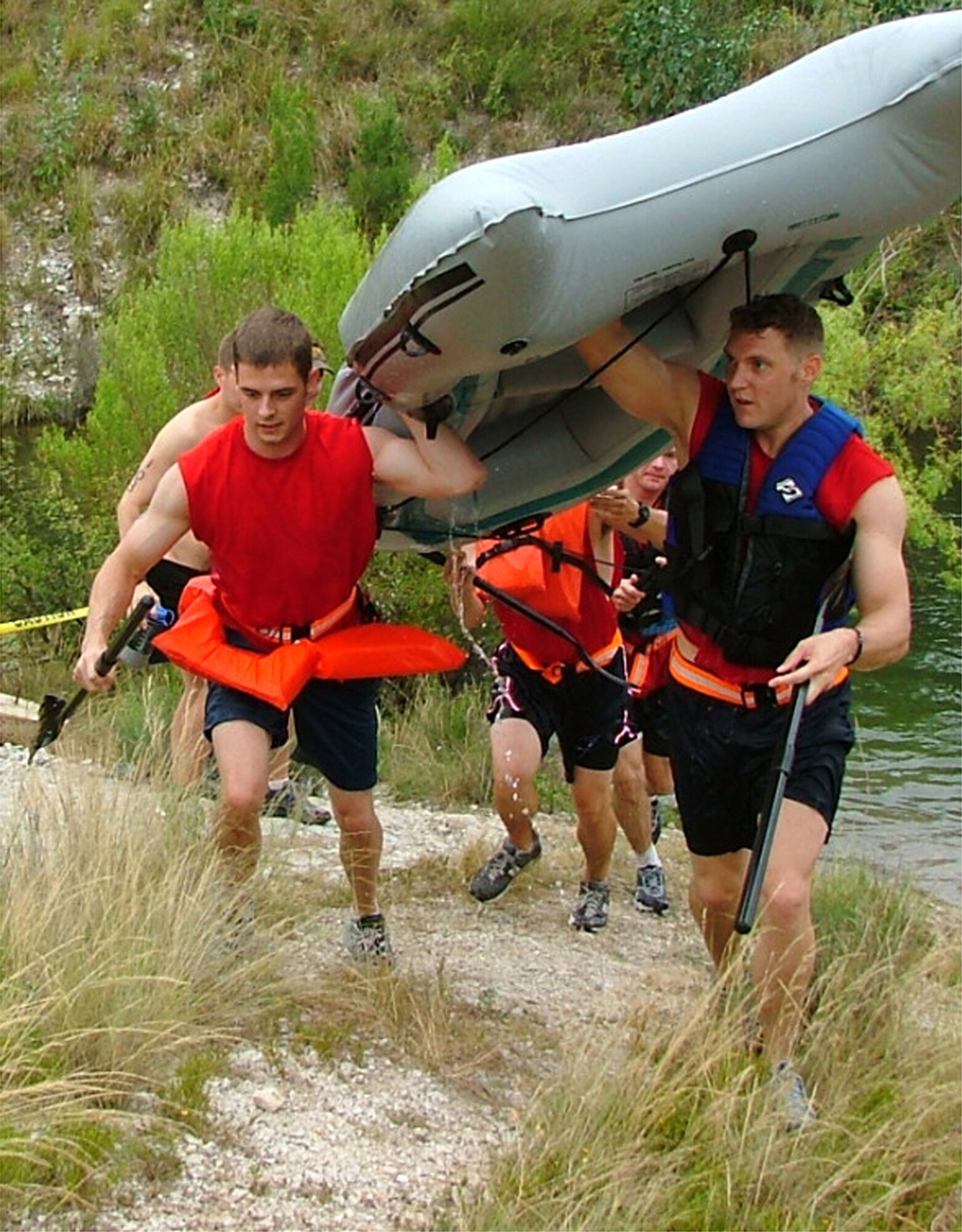 LAUGHLIN AIR FORCE BASE, Texas -- Second Lt. James Lee (left) and Capt. Nate Day lead their team to the finish line after the rafting portion of an adventure race June 12.  More than 100 Airmen from the 86th Flying Training Squadron took part in the unit-sponsored race that included a 22-mile bike ride, a 6-mile run and a four-man rafting event.  (U.S. Air Force photo by Capt. Paula Kurtz)