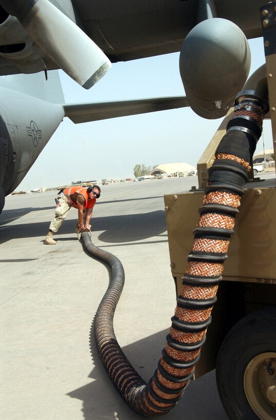 BALAD AIR BASE, Iraq -- Senior Airman Zoltan Keogh prepares an air hose before connecting it to a C-130 Hercules here.  Airman Keogh is a crew chief with the 332nd Expeditionary Air Mobility Squadron and is deployed from the 62nd Aircraft Maintenance Squadron at McChord Air Force Base, Wash.  The C-130 Hercules is deployed from the Georgia Air National Guard's 165th Airlift Wing in Savannah.  (U.S. Air Force photo by Staff Sgt. Jason Lake)