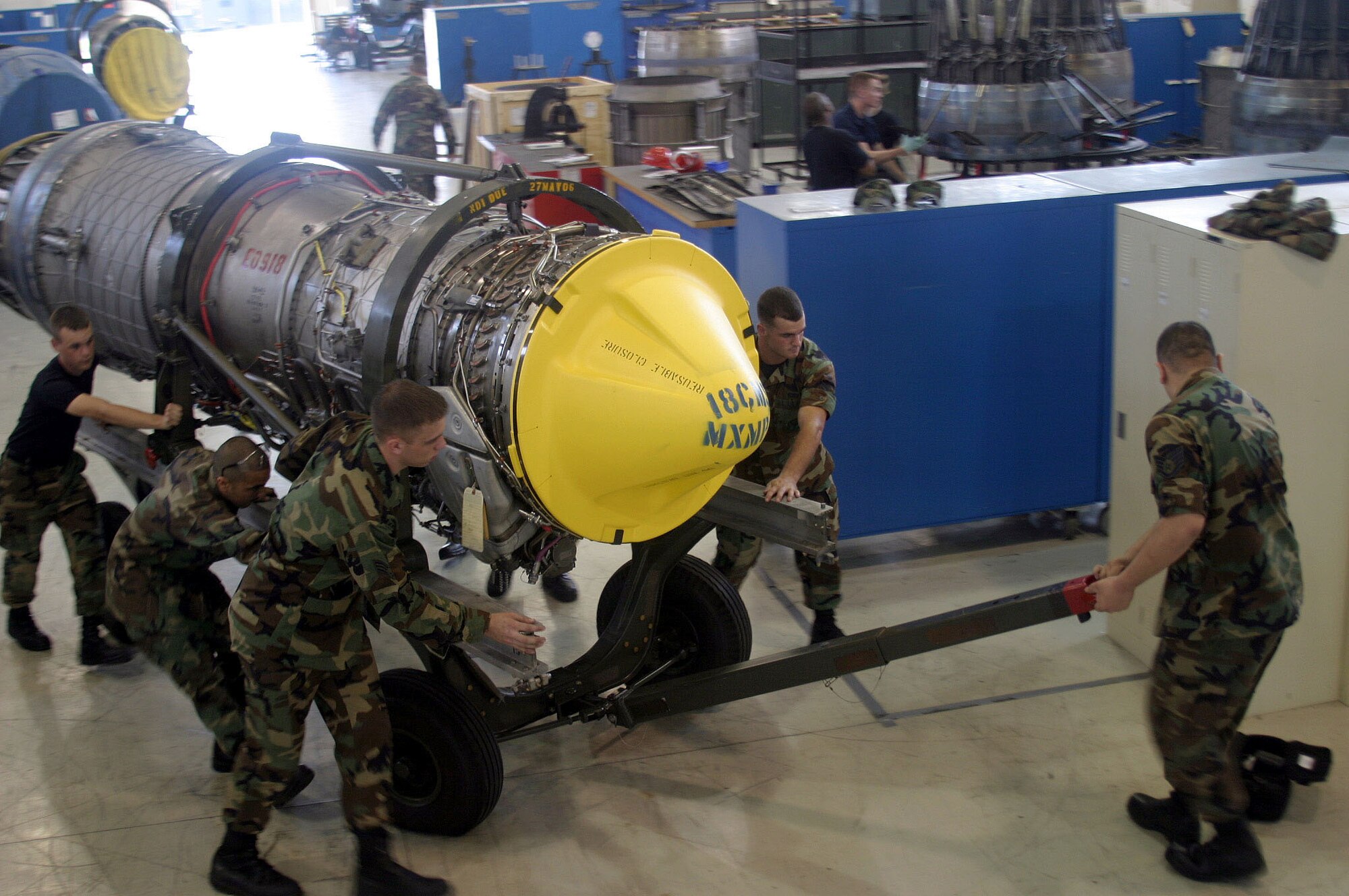 KADENA AIR BASE, Japan -- Jet engine mechanics with the 18th Component Maintenance Squadron move the last upgraded F-15 Eagle engine in a maintenance hangar here.  For the last six years more than 100 mechanics have been upgrading more than 100 F-15 engines from a "Dash 100" model to a "Dash 220E" engine saving the Air Force more than $100 million.  (U.S. Air Force photo by Master Sgt. Adam Johnston)