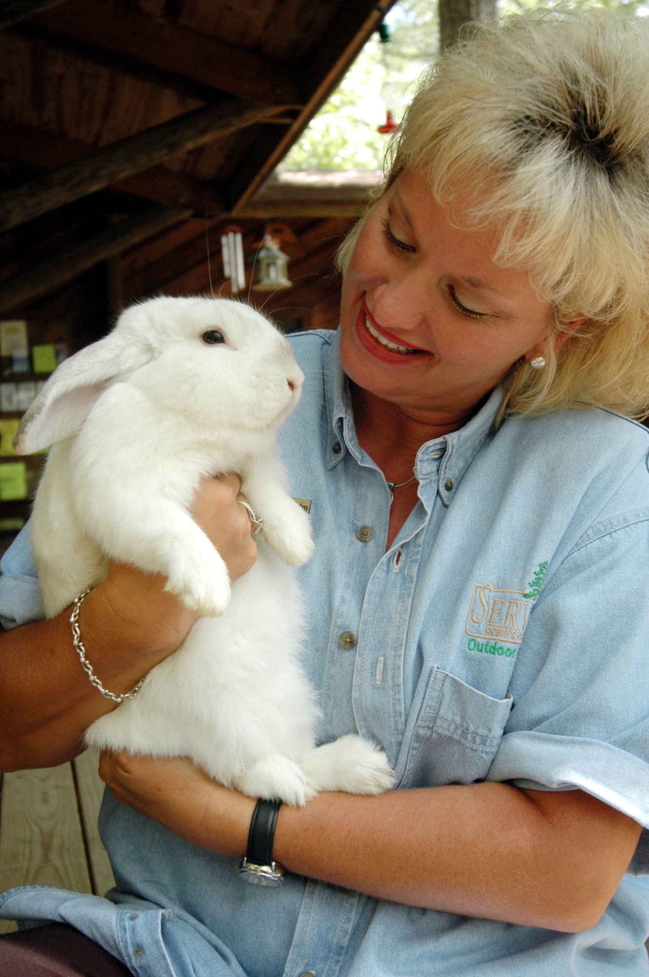ROBINS AIR FORCE BASE, Ga. -- Sharron Wilhelm gives Lucky, a lop-eared rabbit, some tender-loving care.  Ms. Wilhelm is the supervisor for the Spalding Nature Center here.  Besides rabbits, some of the center's animals include snakes, turtles and a variety of birds.  (U.S. Air Force photo by Sue Sapp)
