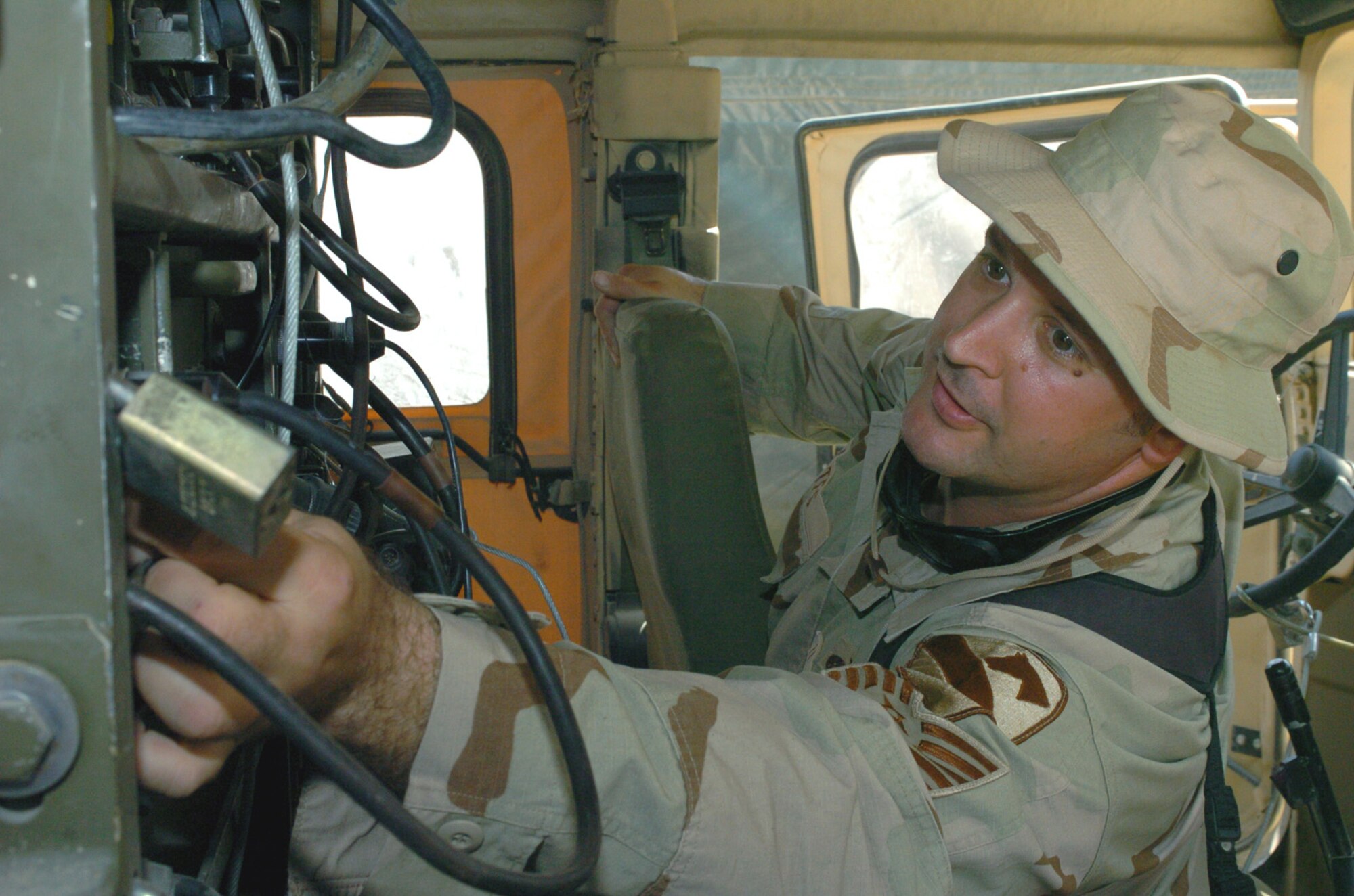 BAGHDAD, Iraq -- Being able to call in air support for the Army requires reliable communications in the field.  Tech. Sgt. Christopher Bates, a radio maintainer for a tactical air control party, ensures that happens.  (U.S. Army photo by Pfc. Bryce Dubee)