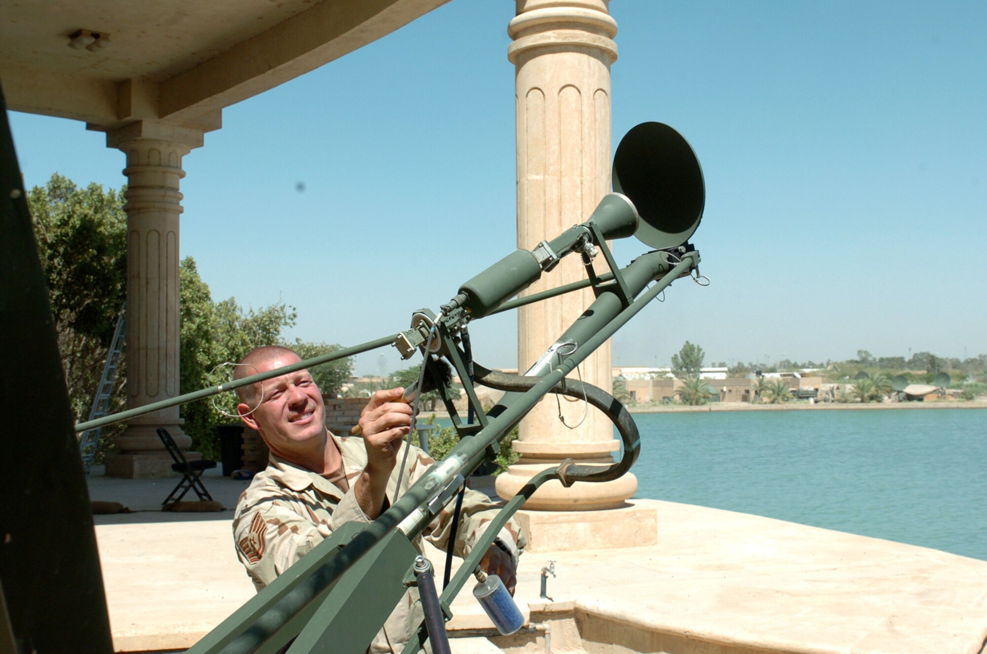 BAGHDAD, Iraq -- Keeping satellite receivers free of debris is just part of a daily checklist for Tech. Sgt. Davi Novak, a noncommissioned officer in charge of satellite communications in Iraq.  He is deployed here as part of a tactical air control party team responsible for calling in air support for Army missions.  (U.S. Army photo by Spc. Joshua Joyce)