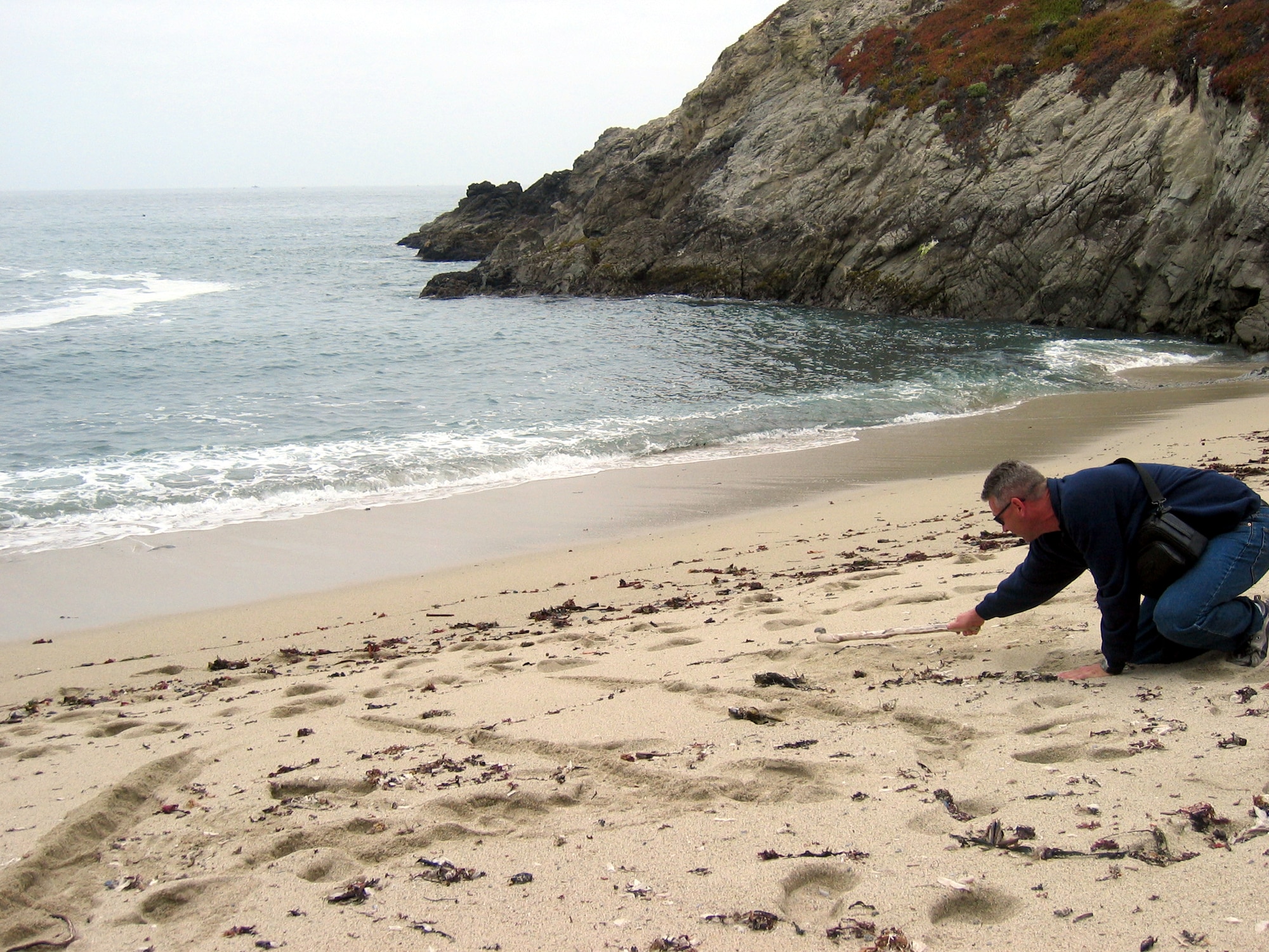 BODEGA BAY, Calif. -- Master Sgt. Craig Silver carves his class number into the beach here.  He is one of four Air Force master sergeants attending the Coast Guard Chief Petty Officer's Academy.  Sergeant Silver is stationed at Travis Air Force Base, Calif.  (U.S. Air Force photo by 1st Lt. Shannon Nyberg)