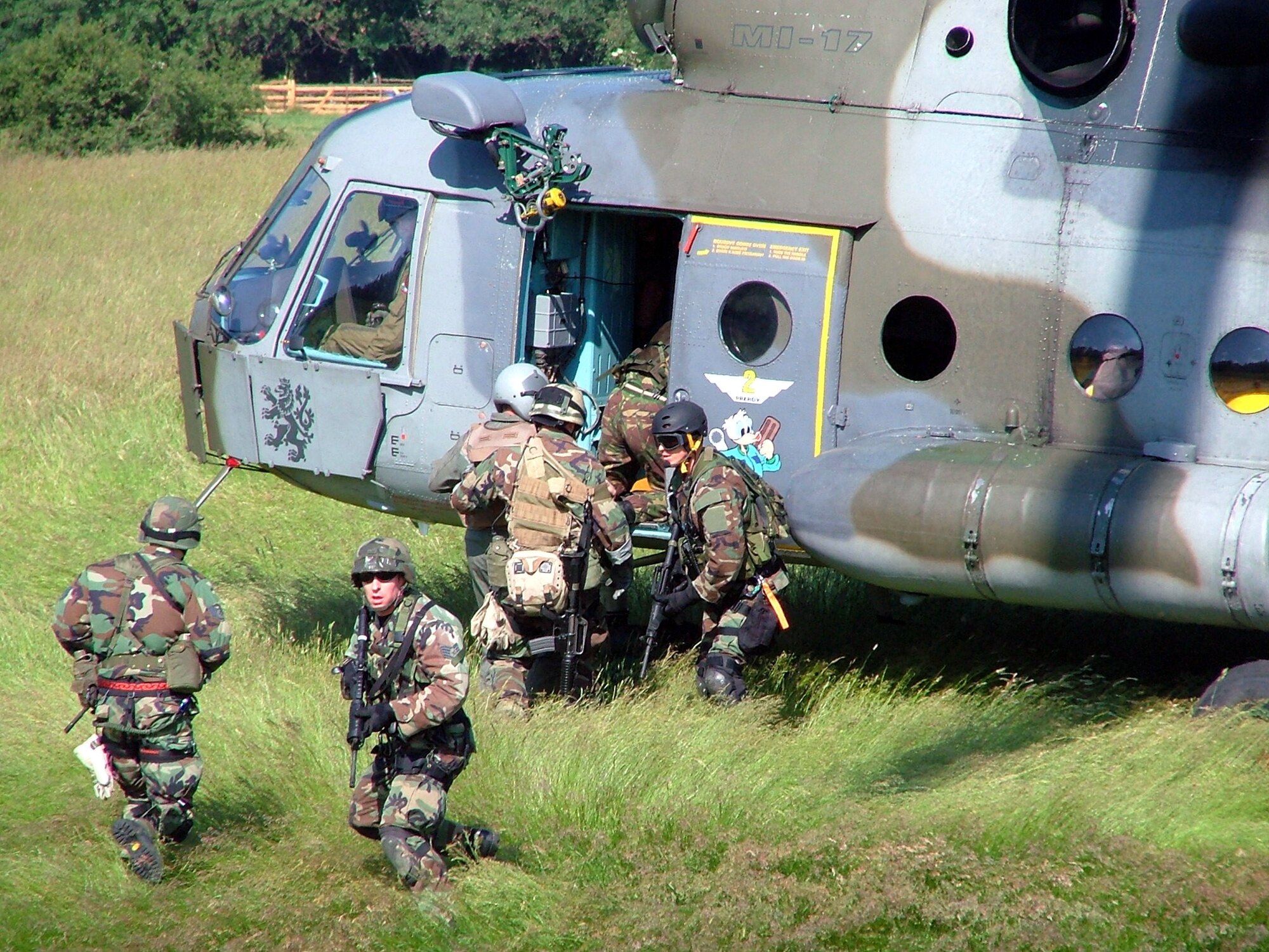 GEORG-FRIEDRICH KASERNE, Germany -- Staff Sgt. Frank Zentek (front) provides security while other members from his team, including a Czech Mi-17 Hip helicopter crew and parajumpers from the 56th Rescue Squadron and British forces, load a "downed pilot" into the helicopter.  Sergeant Zentek is assigned to the 786th Security Forces Squadron at nearby Sembach Air Base.  (U.S. Air Force photo by Jacqueline Hilinski)