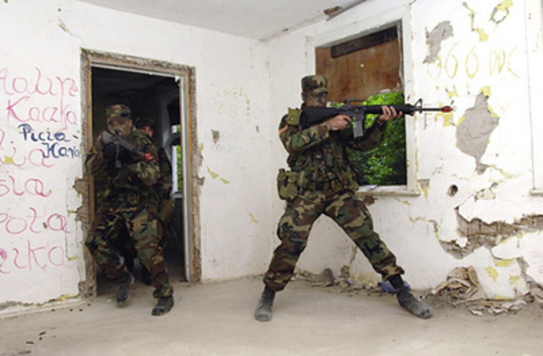 Infantrymen with Charlie Company, 178th Infantry Air Assault, 66th Brigade, 35th Infantry Division, storm a building in Ustka, Poland, during urban assault training for Baltic Operations '04 on June 10, 2004. Baltic Operations '04 is a combined maritime and land exercise in the Baltic Sea that includes NATO and non-NATO participants. 