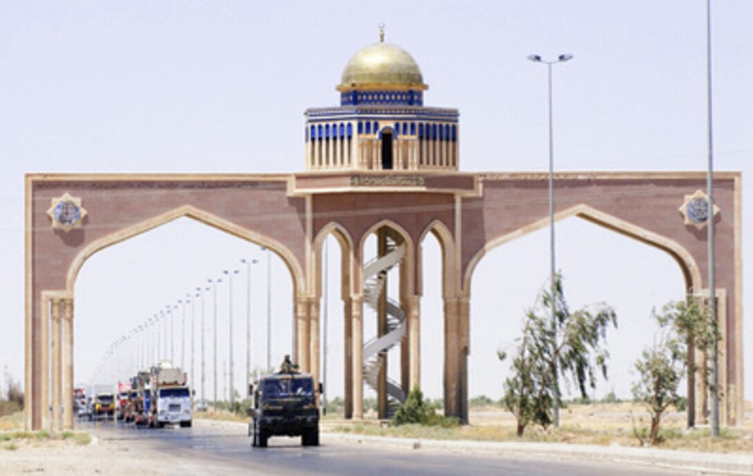 A gun truck from the 2632nd Air Expeditionary Force Transportation Company, 3rd Platoon, moves under an archway on the Main Supply Route as it leads a convoy on June 12, 2004. The 2632nd is providing security to military and civilian convoys as they transport supplies to multiple Forward Operating Bases throughout Iraq. 