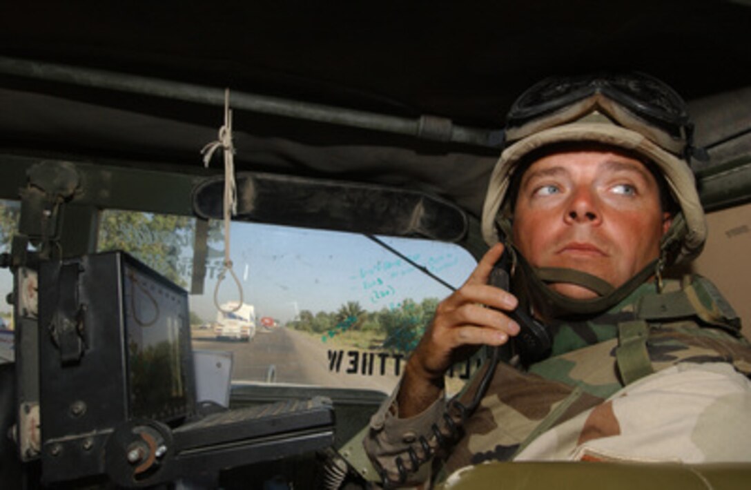 Air Force Master Sgt. Theron Jones monitors the progress of a 67-vehicle convoy along the Main Supply Route in Iraq on June 12, 2004. Jones is the 3rd Platoon Commander from the 2632nd Air Expeditionary Force Transportation Company and is responsible for providing security to military and civilian convoys as they transport supplies to multiple Forward Operating Bases throughout Iraq. 