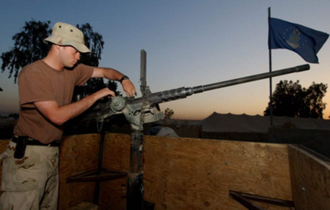 Senior Airman Bryan Fletcher, a vehicle operator with the 2632nd Air Expeditionary Force Transportation Company, checks a M2 .50-caliber machine gun prior to the arrival of a convoy in Iraq on June 12, 2004. The 2632nd is responsible for providing security to military and civilian convoys as they transport supplies to multiple Forward Operating Bases throughout Iraq. 