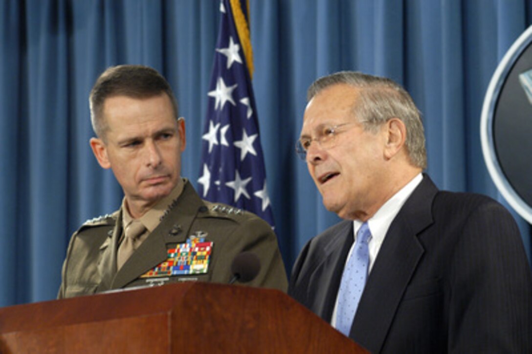 Secretary of Defense Donald H. Rumsfeld (right) responds to a reporter's question during the June 17, 2004, Pentagon press briefing with Vice Chairman of the Joint Chiefs of Staff Gen. Peter Pace, U.S. Marine Corps. Rumsfeld and Pace updated reporters on Iraq and took questions. 