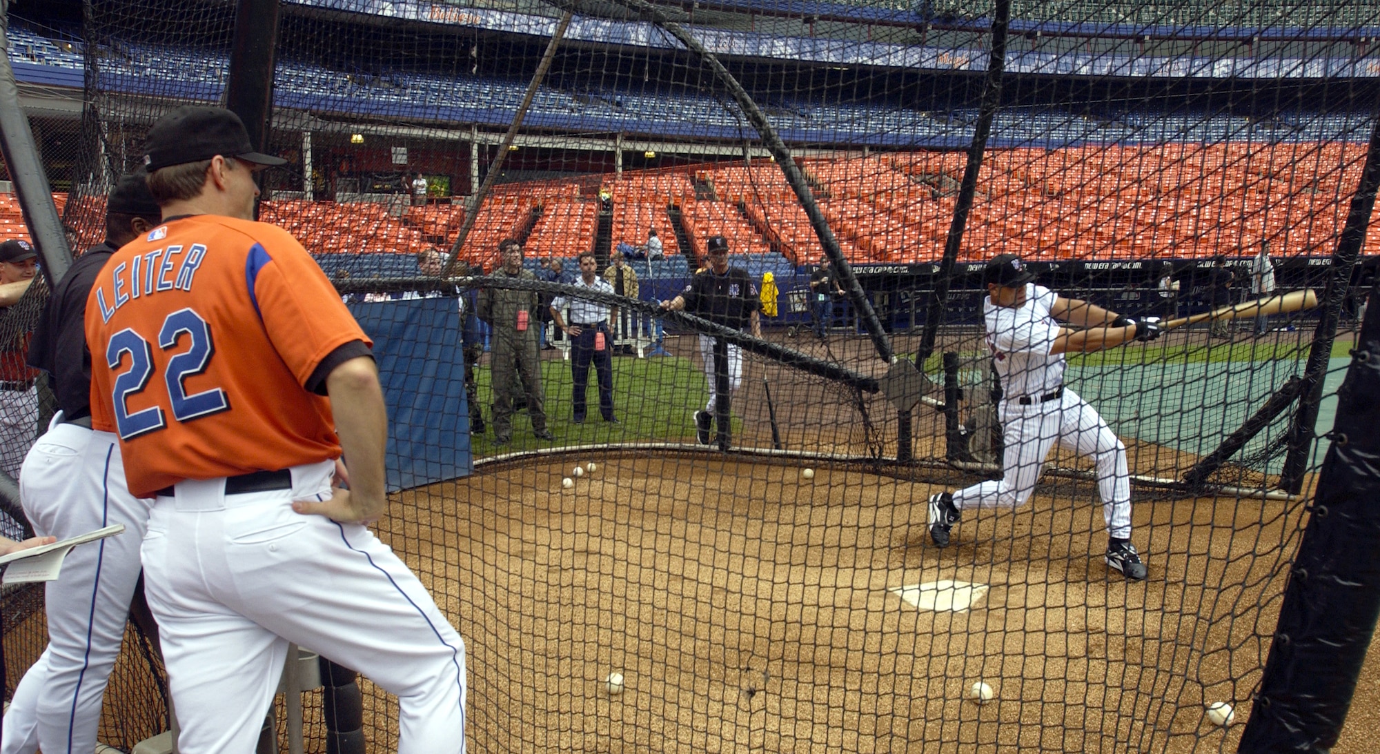 NEW YORK -- New York Mets pitcher Al Leiter watches Senior Airman Chardo Richardson takes a cut at a ball in batting practice with the New York Mets here June 22.  Airman Richardson was at Shea Stadium for the second part of a job swap with Mr. Leiter.  The Mets pitcher was a boom operator for a day at McGuire Air Force Base, N.J., on May 24.  Airman Richardson is a boom operator with the 32nd Air Refueling Squadron at McGuire.  (U.S. Air Force photo by Kenn Mann)