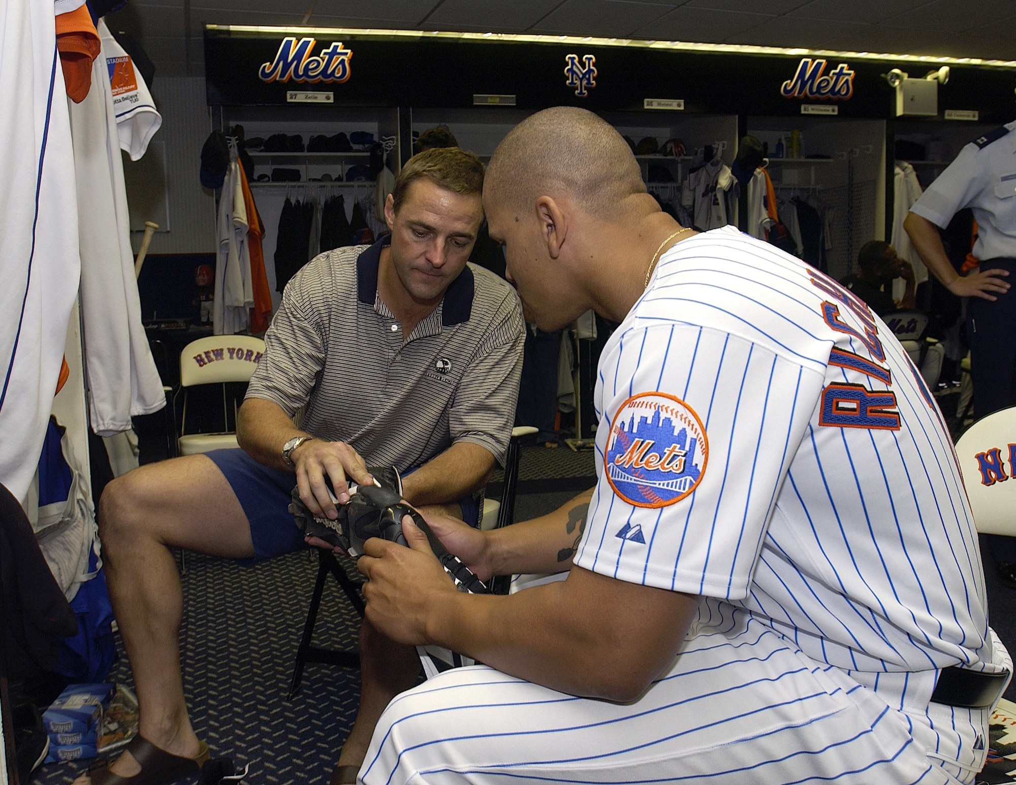 NEW YORK -- New York Mets pitcher Al Leiter gives a pair of cleats to Senior Airman Chardo Richardson at Shea Stadium on June 22.  Airman Richardson was here for the second part of a job swap with Mr. Leiter.  The Mets pitcher was a boom operator for a day at McGuire Air Force Base, N.J., on May 24.  Airman Richardson is a boom operator with the 32nd Air Refueling Squadron at McGuire.  (U.S. Air Force photo by Kenn Mann)