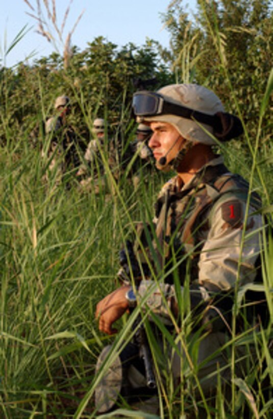 Army Spc. Ricardo Morales surveys the horizon for hostile activity during a Quick Response Force mission on June 19, 2004. The Quick Response Force responds to immediate action situations directed by the Tactical Operations Center commander. Morales is assigned as the Bravo Section Gunner of the 2nd Brigade Reconnaissance Troop. 