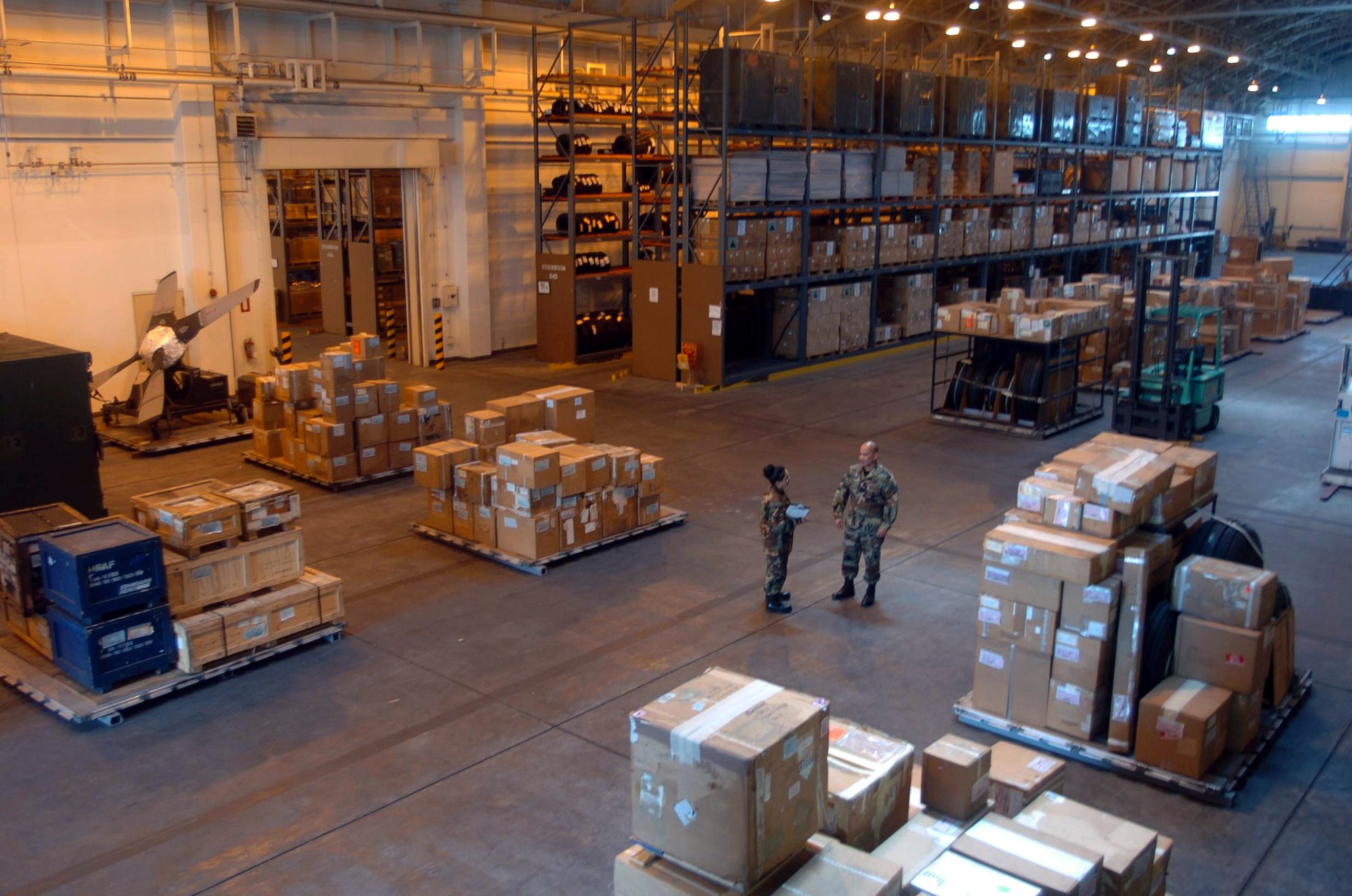 YOKOTA AIR BASE, Japan - Tech. Sgt. Rex Sarmiento (right) and Airman 1st Class Amadel Aspiras discuss equipment storage procedures during an inspection here.  Both Airmen are inventory management technicians assigned to the 374th Logistics Readiness Squadron's aircraft parts store element.  (U.S. Air Force photo by Master Sgt. Val Gempis)