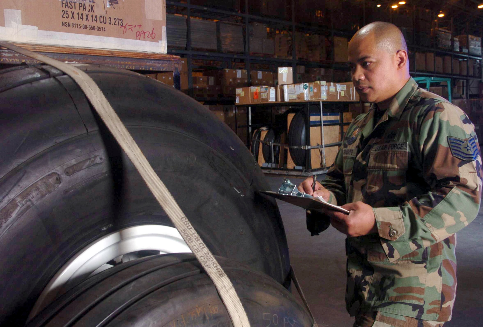 YOKOTA AIR BASE, Japan -- Tech. Sgt. Rex Sarmiento inspect a pallet full of aircraft equipment at the aircraft parts facility here.  He is an inventory management technician assigned to the 374th Logistics Readiness Squadron's aircraft parts store element.  (U.S. Air Force photo by Master Sgt. Val Gempis)