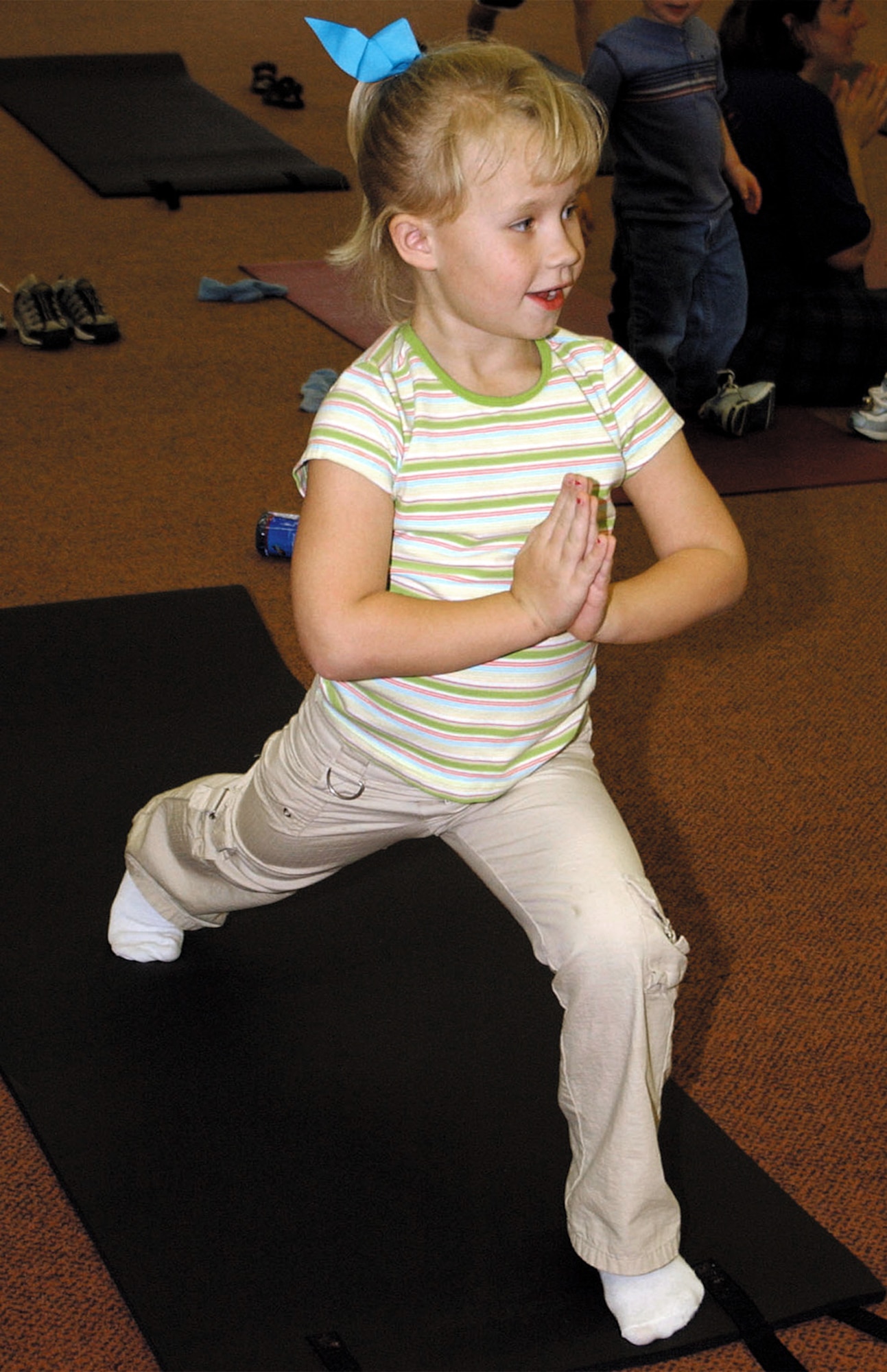 MINOT AIR FORCE BASE, N.D. -- Emily Wilson performs a yoga stance during a children's yoga class here June 21.  Besides the traditional stretching and balancing, the class includes children posing like cobra, monkeys and airplanes. (U.S. Air Force photo by Airman 1st Class Fallon Shea)