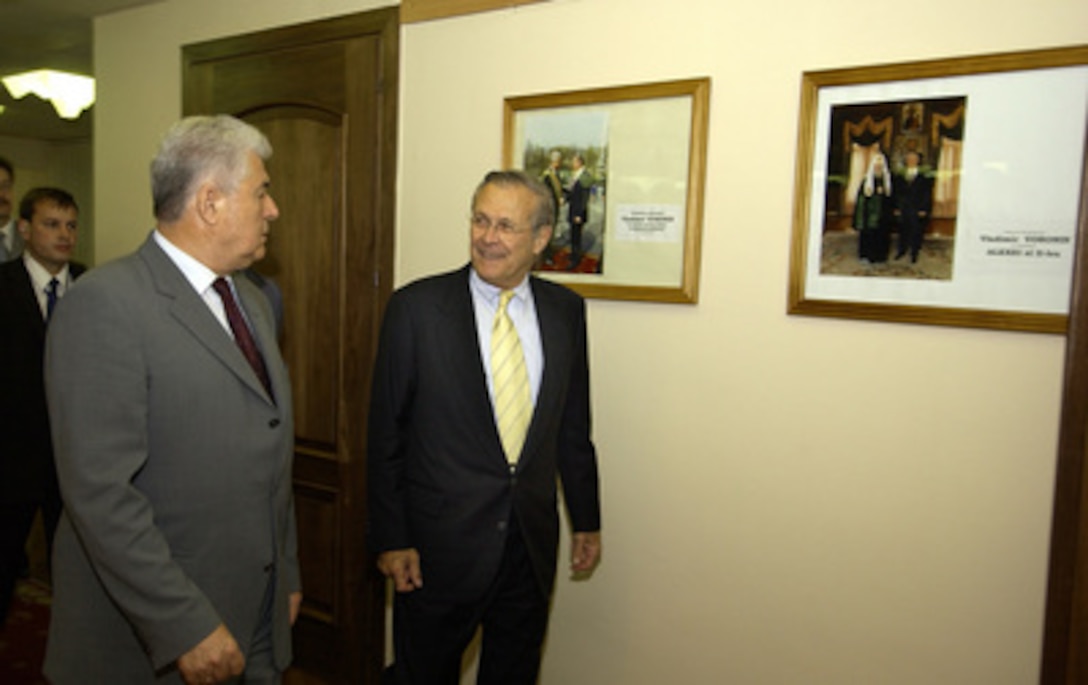 Secretary of Defense Donald H. Rumsfeld (right) and Moldovan President Vladimir Voronin walk to their meeting in the capitol building in Chisinau, Moldova, on June 26, 2004. Rumsfeld stopped in Moldova to thank them for their contribution to the coalition in Iraq, on his way to the NATO Summit in Istanbul, Turkey. 