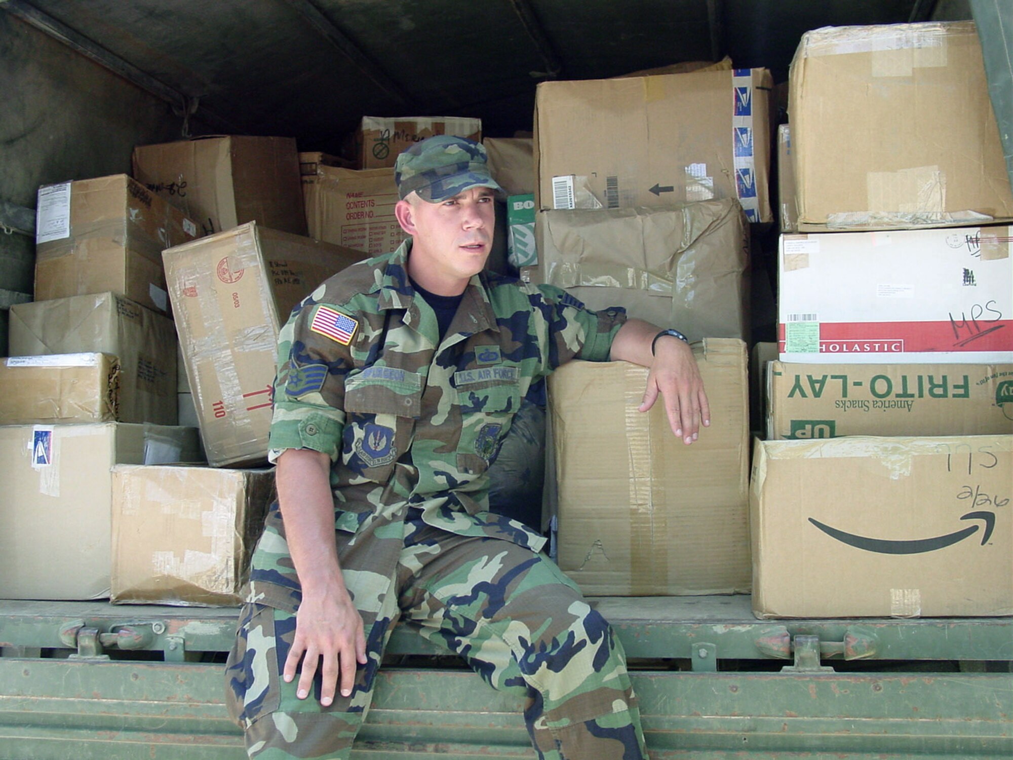 PRISTINA, Kosovo -- Staff Sgt. Bill Spurgeon takes a break after loading more than 80 boxes onto a truck for a 40-mile trip to a children's shelter here June 27.  Sergeant Spurgeon is a disbursing noncommissioned officer at Kosovo Force headquarters and is deployed from Royal Air Force Lakenheath, England.  (U.S. Air Force photo by Master Sgt. Tim Helton)