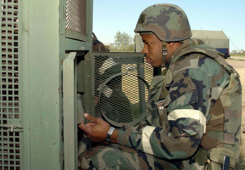 MINOT AIR FORCE BASE, N.D. -- Senior Airman Oba Lewis tries to start a refrigeration unit during an attack exercise here June 28.  The exercise simulated a bare-base environment to test the wartime skills of Airmen.  Airman Lewis is assigned to the 5th Civil Engineer Squadron.  (U. S. Air Force photo by Airman 1st Class Fallon Shea)