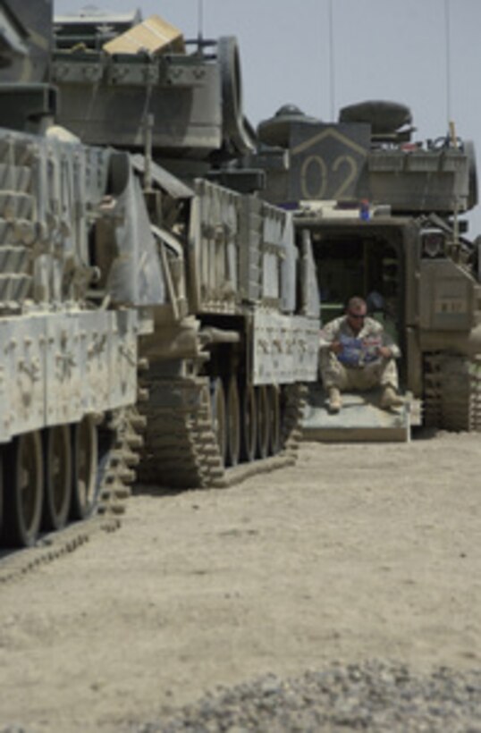 A soldier from 2nd Brigade Combat Team, 1st Armored Division, takes some time to relax prior to Operation Thunder Tornado which is a joint operation with U.S. and Iraqi soldiers to hit key targets in Jusr As Sukr, on June 9, 2004. 