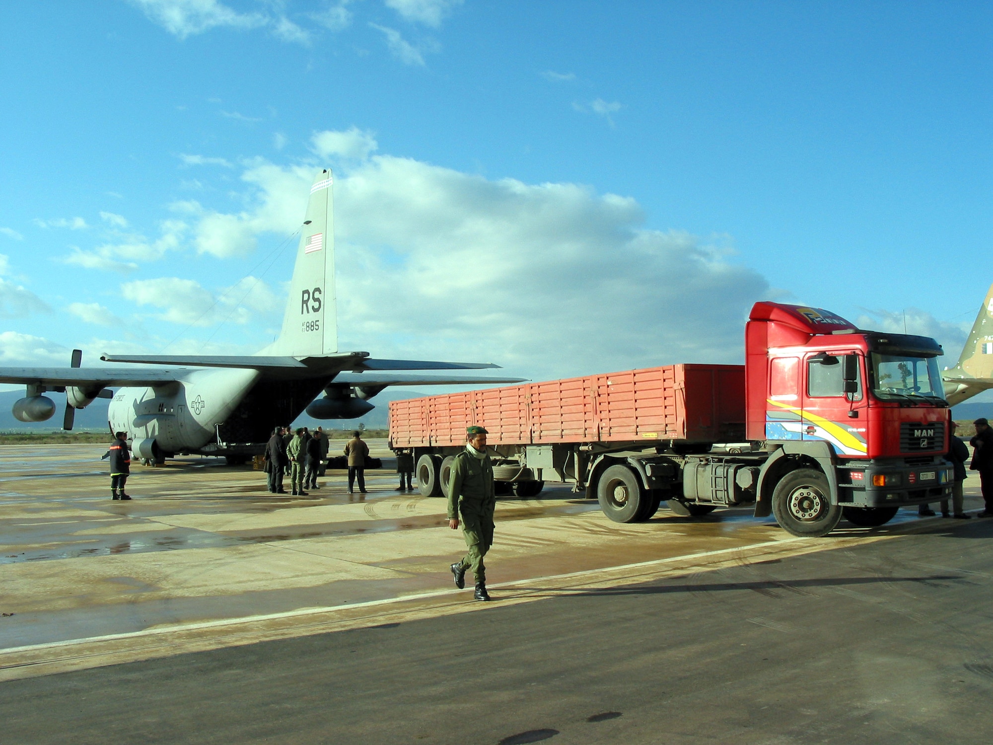 AL HOCEIMA, Morocco -- Workers at Nador Airport in northern Morocco prepare to unload four pallets of humanitarian relief supplies Feb. 28 from an Air Force C-130 Hercules.  The C-130 is assigned to the 37th Airlift Squadron at Ramstein Air Base, Germany.  (U.S. Air Force photo by Tech. Sgt. Bob Purtiman)