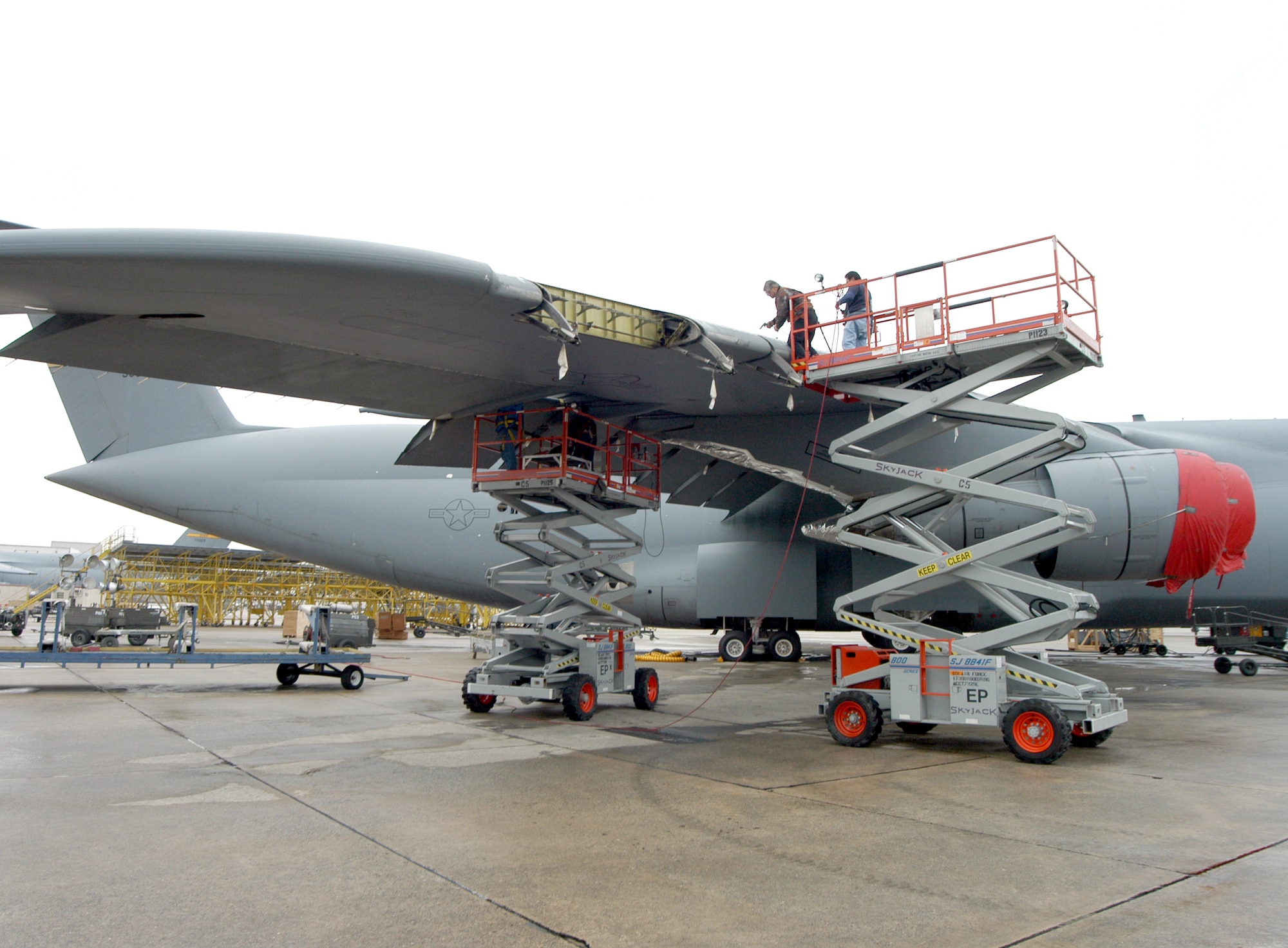 ROBINS AIR FORCE BASE, Ga. -- The C-5 Galaxy that was hit by a missile shortly after takeoff in Iraq on Jan. 8 receives permanent repairs here.  The aircraft was returned to Air Mobility Command on Feb. 23.  (U.S. Air Force photo by Sue Sapp)