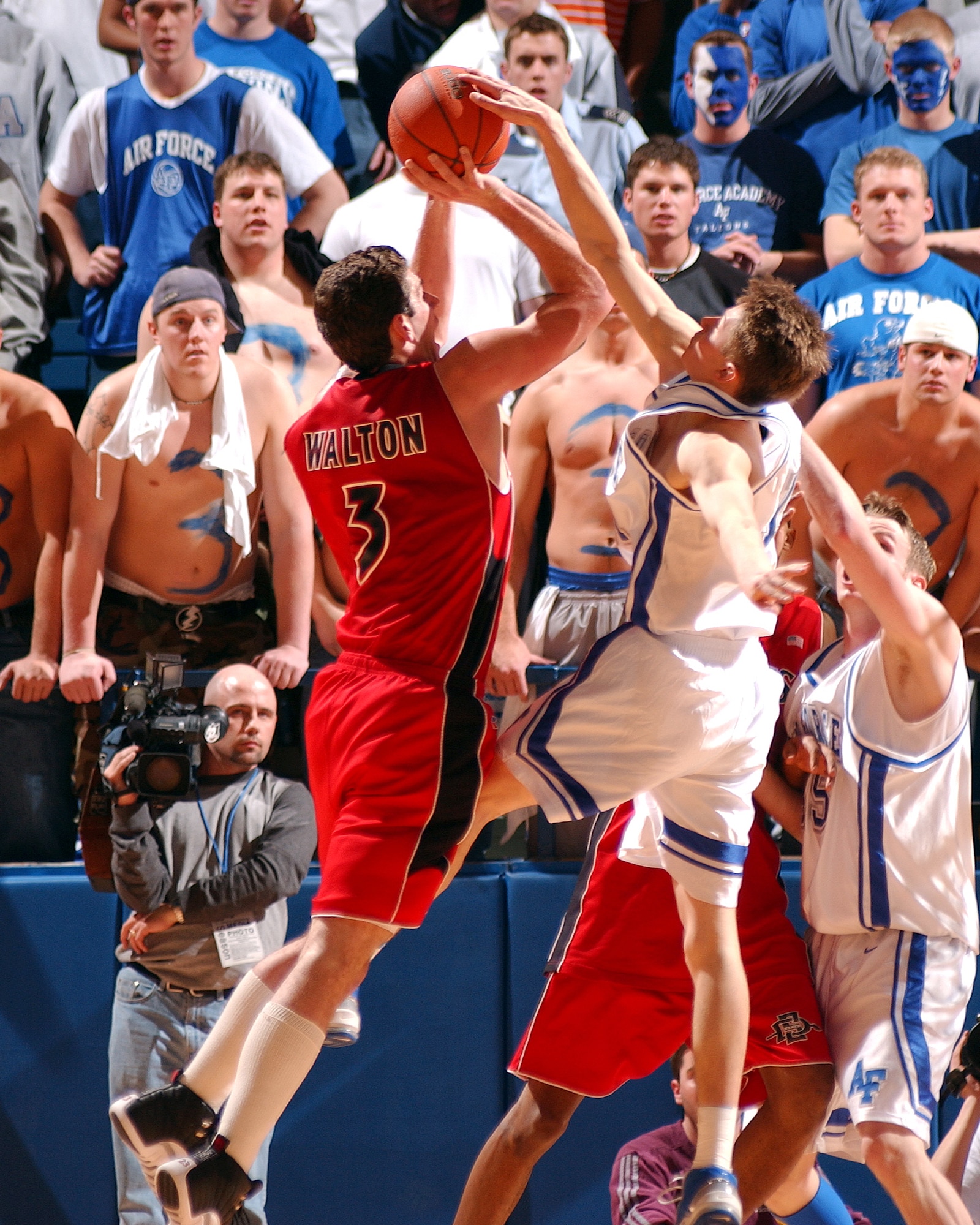 U.S. AIR FORCE ACADEMY, Colo. -- Air Force senior guard Tim Keller spoils the shot of San Diego State forward Chris Walton, during the Falcon's 61-49 win over the Aztecs.  With the win, Air Force boosted its conference record to 11-2 and its overall record to 21-5, winning its first Mountain West Conference championship in men's basketball.  The Falcons close out regular season play March 6 at the University of Wyoming.  (U.S. Air Force photo by Danny Meyer)