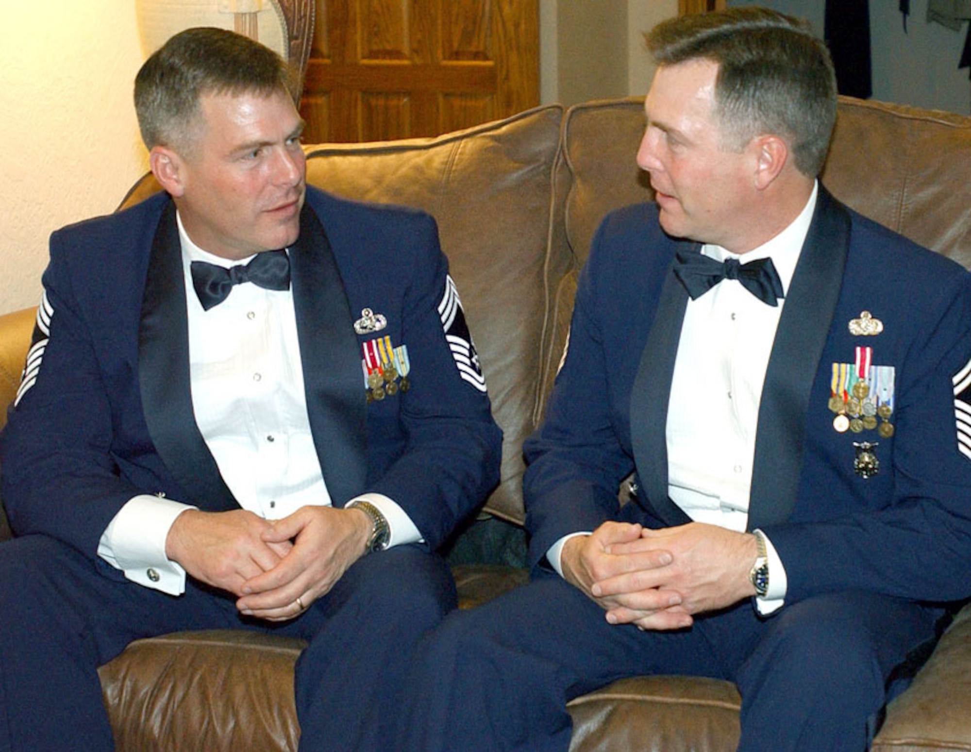 CANNON AIR FORCE BASE, N.M. -- Chief Master Sgt. Evan Godwin (left) and his twin brother, Ivan, share a moment before Ivan's chief master sergeant induction ceremony here.  Evan is a weapons chief with the 18th Wing at Kadena Air Base, Japan, and Ivan is the fire chief with the 27th Civil Engineer Squadron here.  (U.S. Air Force photo by Staff Sgt. April Kujawski)