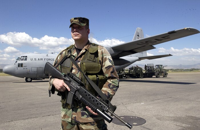 PORT-AU-PRINCE, Haiti -- Senior Airman Rick Montonario secures the ramp here as a C-130 Hercules from Dyess Air Force Base, Texas, is being unloaded March 3.  Airman Montonario is assigned to the 437th Security Forces Squadron at Charleston AFB, S.C.  (U.S. Air Force photo by Tech. Sgt. Andy Dunaway)