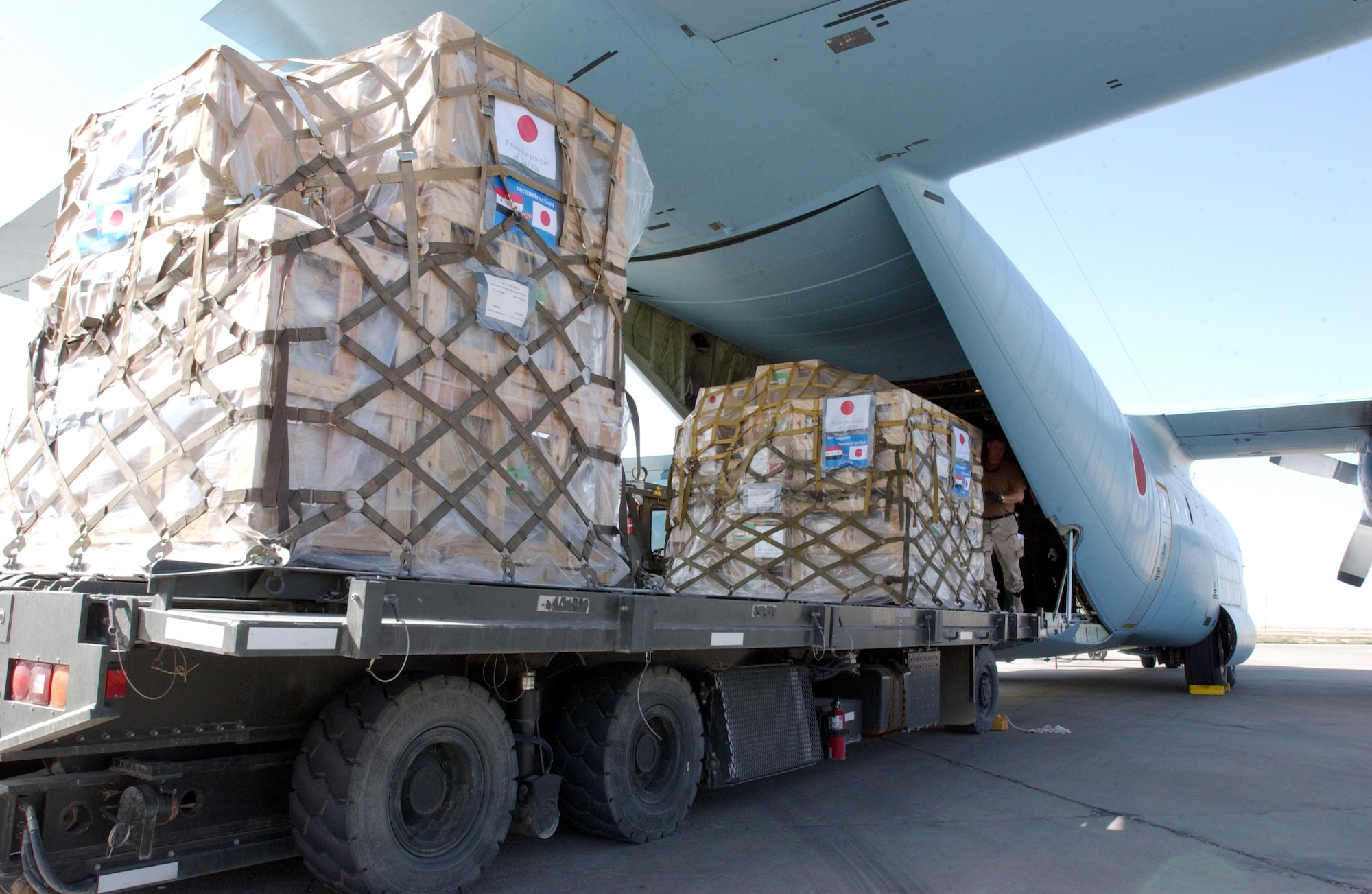 TALLIL AIR BASE, Iraq -- Airmen from the United States and Japan unloaded more than 5,000 pounds of humanitarian supplies here March 3.  The Japanese C-130 flew that country's first airlift mission into Iraq.  (U.S. Air Force photo by Staff Sgt. Chenzira Mallory)