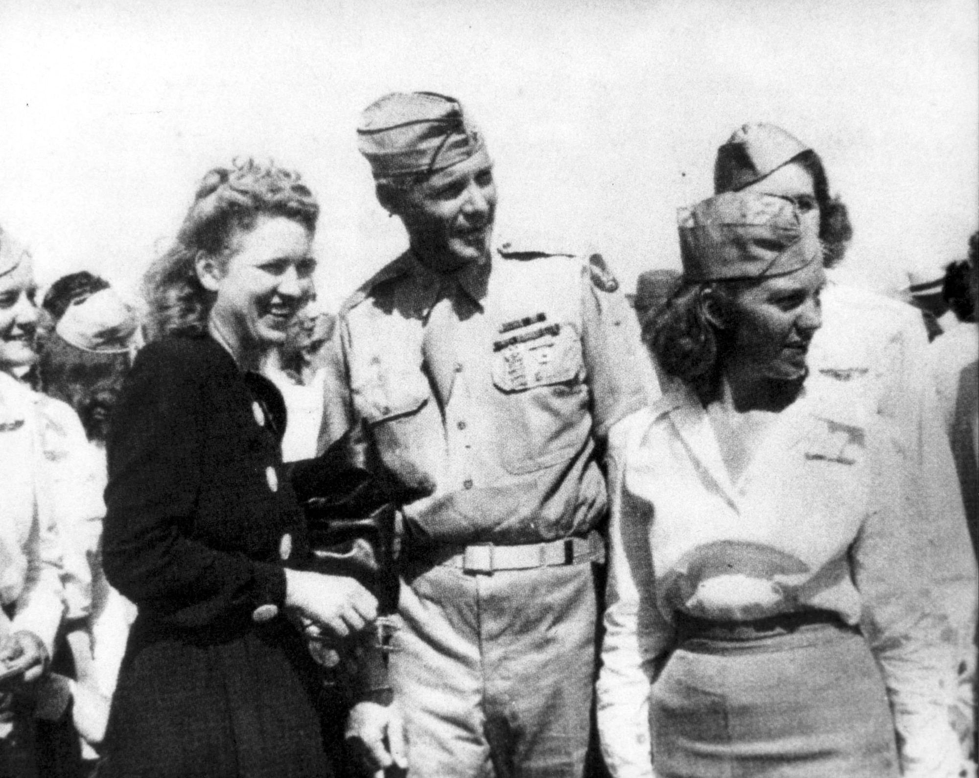 SWEETWATER, Texas -- World-class aviator Jackie Cochran (left) with her adjutant officer (center) is surrounded by pilot trainees at a training field near here.  (Courtesy photo)