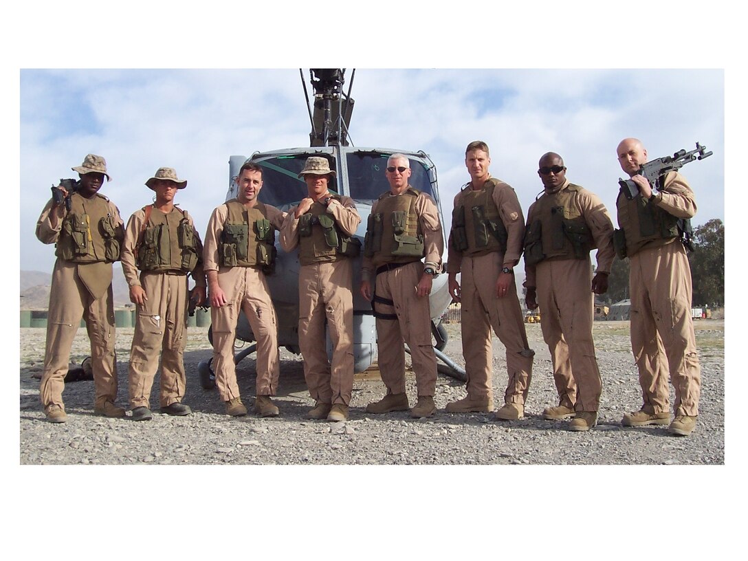 Capt. Scott Meehan (3rd from left), a UH-1N Huey helicopter pilot, stands with his flight crew on an expeditionary airfield at Forward Operating Base Salerno here March 6, 2004.  Detachments from Marine Light Attack Helicopter Squadron 773, a reserve unit based out of Atlanta, Ga., Belle Chasse, La., and Johnstown, Pa., have deployed several times in the past eight years in support of overseas contingency operations.  Meehan, now a lieutenant colonel in the Active Reserve program, currently works in the 4th Marine Aircraft Wing Operations department in New Orleans.