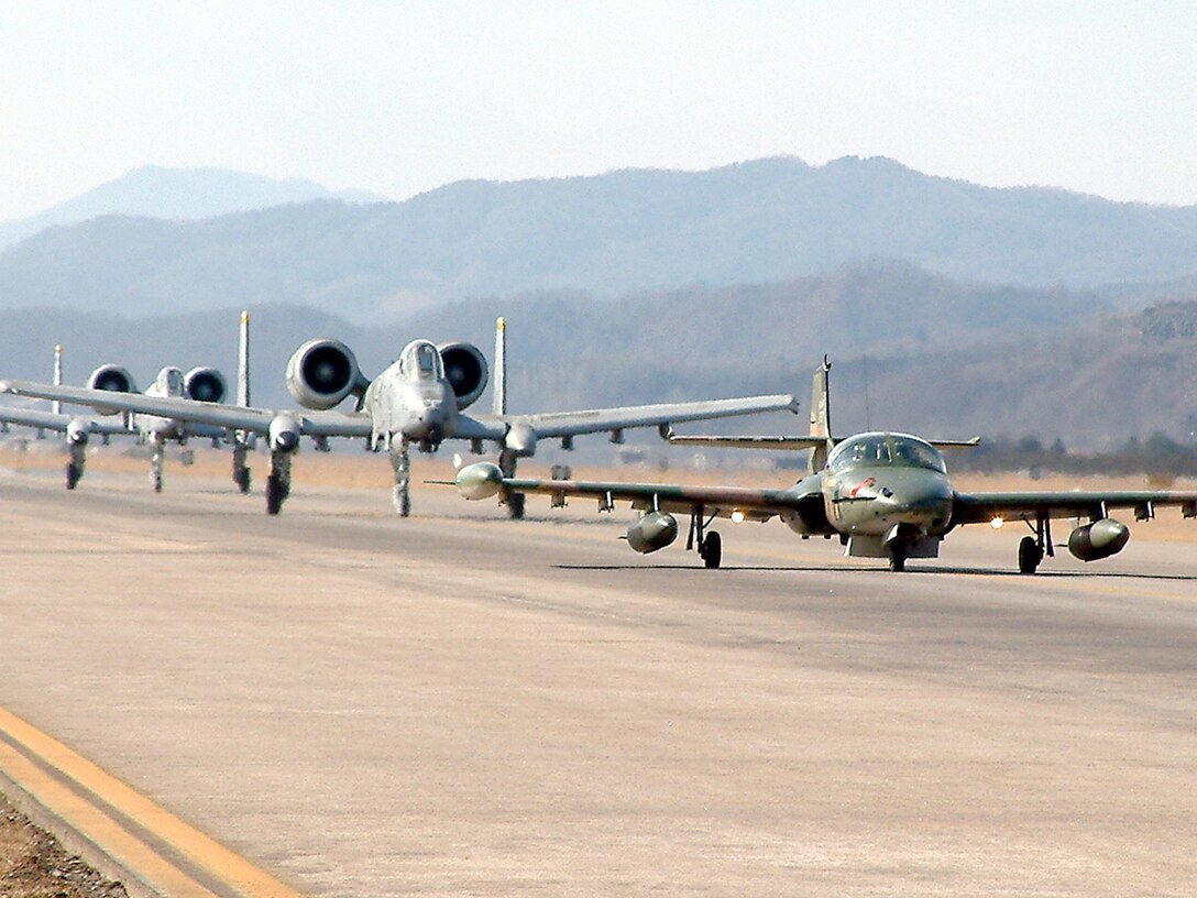 WONJU AIR BASE, South Korea -- A South Korean air force A-37 leads two A-10 Thunderbolt IIs from the 25th Fighter Squadron at Osan Air Base, South Korea, down the taxiway here.  Pilots from the 25th FS along with 10 maintainers and a five-person security forces team took part in an exercise that focused on forward-air control and coordinating command and control of multinational forces.  (Courtesy photo)