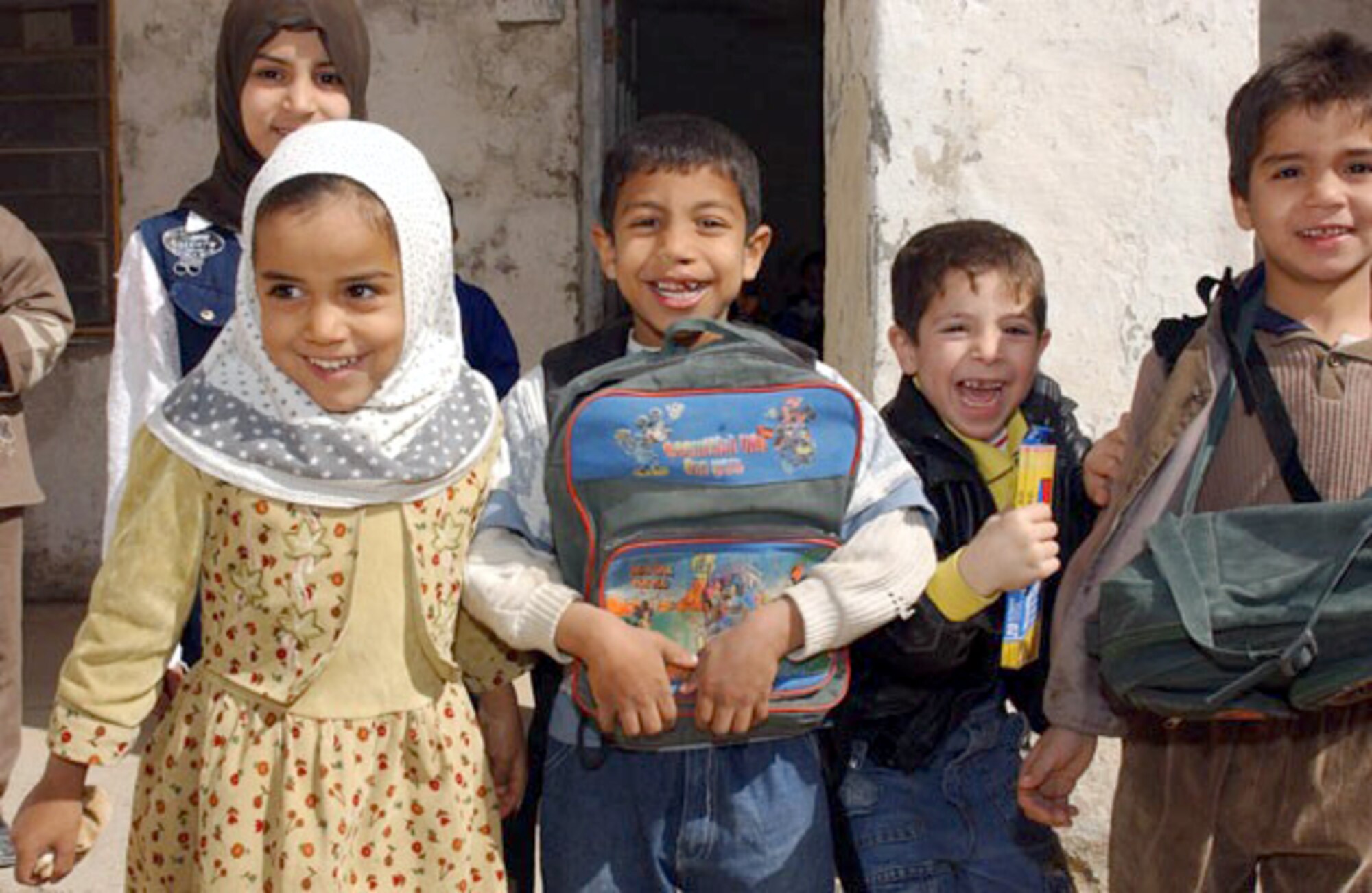 NASIRIYA, Iraq -- Children from a local school select their backpacks donated by 380th Air Expeditionary Wing Airmen.  More than 200 backpacks filled with school supplies and hygiene products were donated.  (U.S. Air Force photo by Tech. Sgt. Bob Oldham)