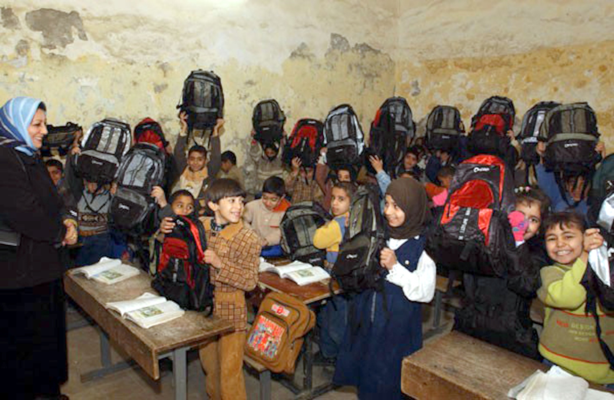 NASIRIYA, Iraq -- Students from a local school open their backpacks recently donated by 380th Air Expeditionary Wing Airmen.  More than 200 backpacks filled with school supplies and hygiene products were donated.  (U.S. Air Force photo by Tech. Sgt. Bob Oldham)