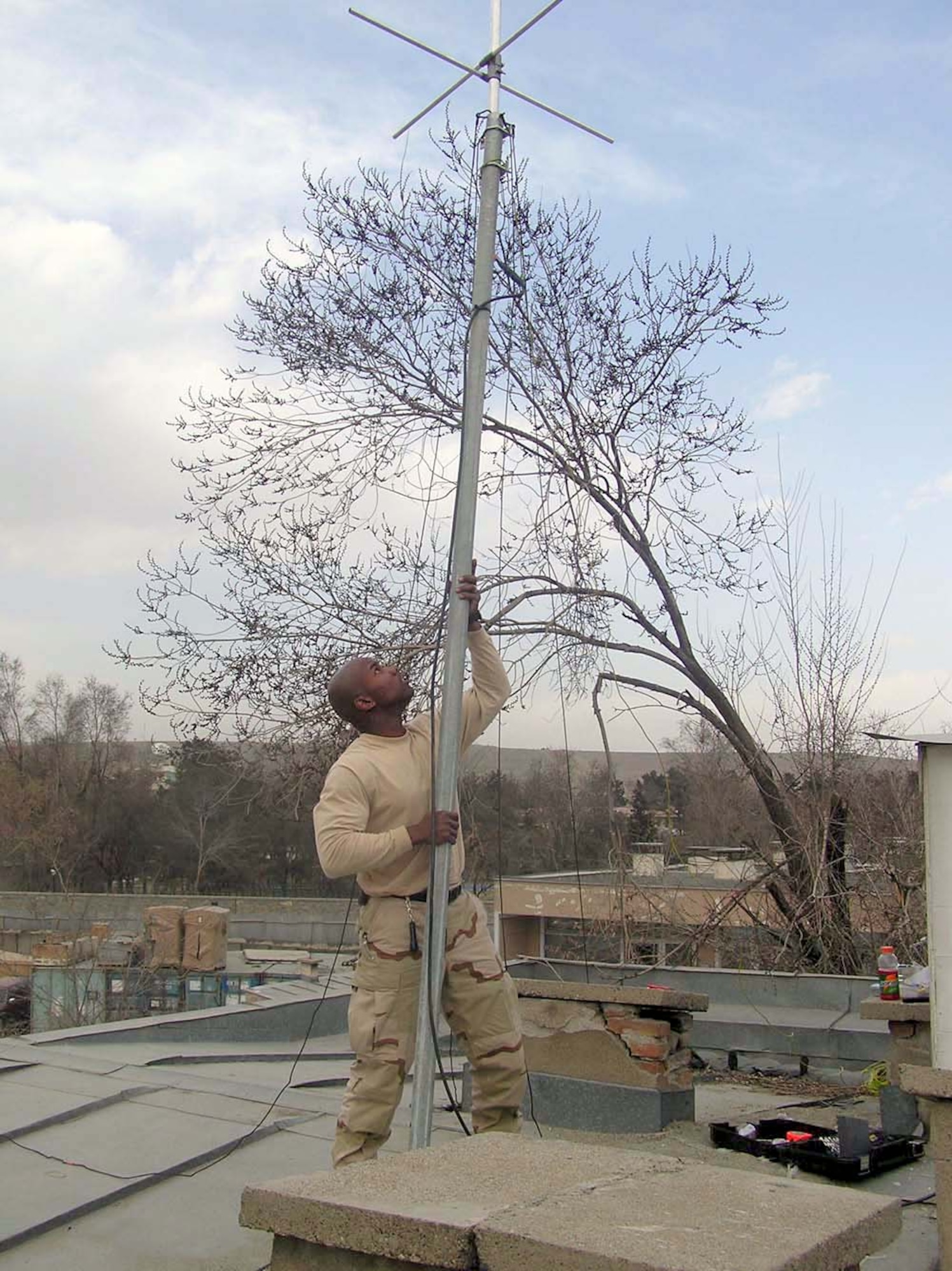 KABUL, Afghanistan -- Staff Sgt. Andre Locust mounts an antenna for the local Army's Criminal Investigative Division.  His work expanded radio communications in the area by up to 10 miles and enhanced operational security for U.S. forces working here.  Sergeant Locust is a ground-radio technician with the 455th Expeditionary Operations Group at Bagram Air Base, Afghanistan.  (U.S. Air Force photo by Staff Sgt. Vincent Bess)