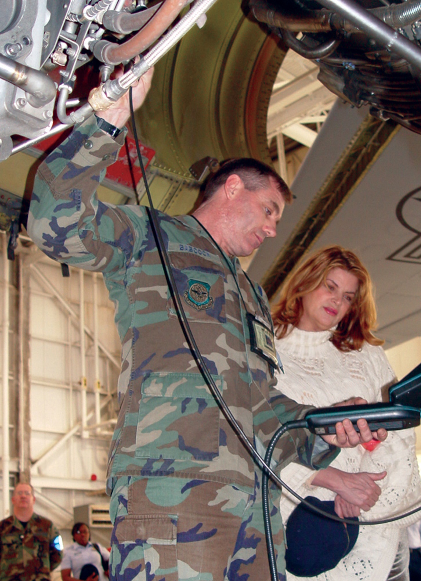 MCCONNELL AIR FORCE BASE, Kan. -- Master Sgt. Gary Babcock shows Golden Globe-winning actress Kirstie Alley the inner workings of the KC-135 Stratotanker engine.  Ms. Alley visited here March 8 to show her support for the troops.  Sergeant Babcock is assigned to the 22nd Maintenance Squadron here.  (U.S. Air Force photo by Airman 1st Class Harold Barnes III)