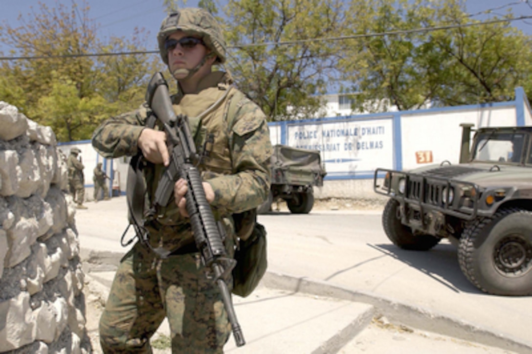 U.S. Marines from the 3rd Battalion, 8th Marine Regiment, Camp Lejeune, N.C., provide security at Haitian police stations in Port-au-Prince, Haiti, on March 6, 2004. Director General Haitian National Police Chief Leon Charles is reorganizing local police stations while working with U.S. Marines deploying to Haiti at the request of the new President of Haiti to help promote the constitutional political process, to create conditions for the arrival of the U.N. multinational force, facilitate humanitarian assistance and secure key sites in the Haitian capital of Port-au-Prince. 