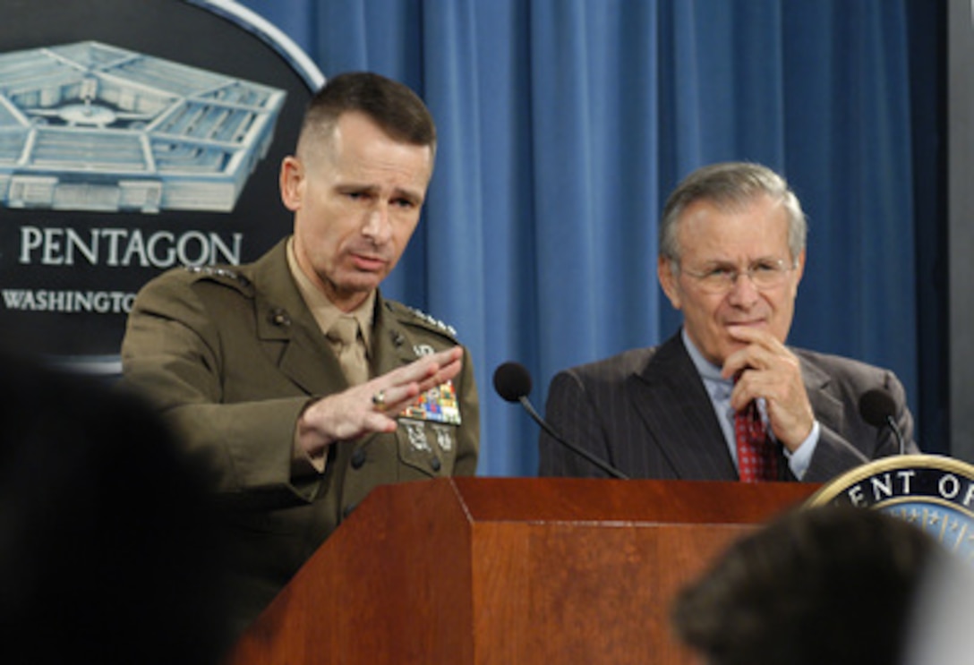 Vice Chairman of the Joint Chiefs of Staff Gen. Peter Pace, U.S. Marine Corps, (left) responds to a reporter's question. Pace and Secretary of Defense Donald H. Rumsfeld conducted the joint press briefing in the Pentagon on March 9, 2004. 