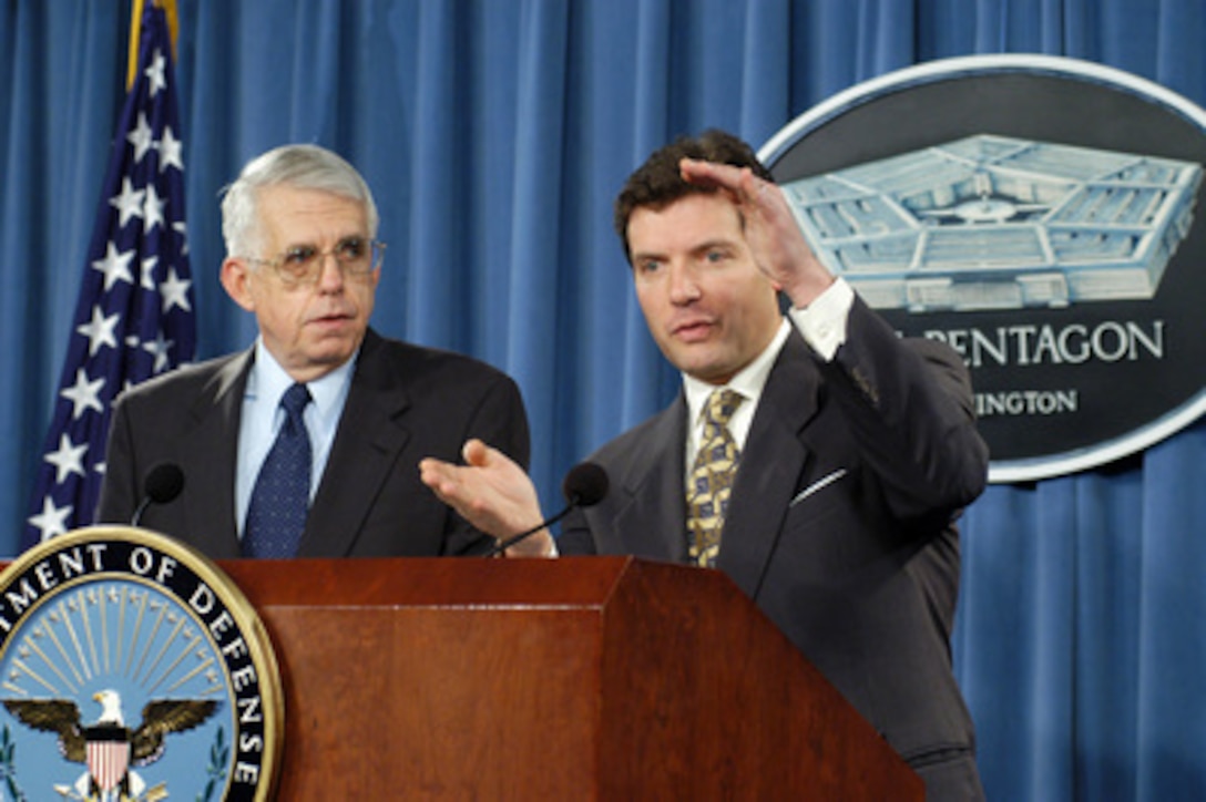 Principal Deputy Assistant Secretary of Defense for Public Affairs Lawrence Di Rita (right) responds to a reporter's question during a March 10, 2004, Pentagon press briefing with David Nash (left). Di Rita and Nash discussed the awarding of reconstruction contracts in Iraq. Nash is the director of the Iraq Program Management Office that functions as part of the Coalition Provisional Authority in Iraq. 