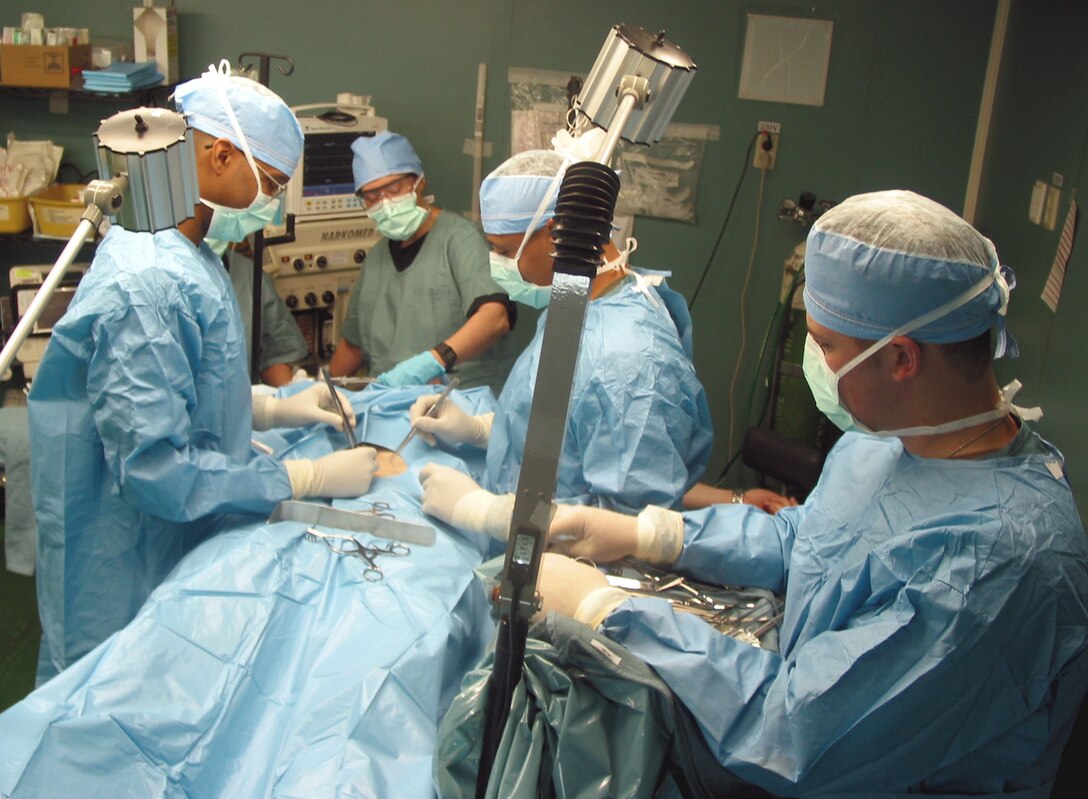MANAS AIR BASE, Kyrgyzstan -- (From left to right) Capt. (Dr.) Andre Graham, Senior Airman Nathan Vanepps, Staff Sgt. Chris McDaniel, Lt. Col. Deborah Cleary and Maj. Delia Zorrilla practice surgical techniques on a simulated patient.  They are all part of the 376th Expeditionary Medical Group's surgical team.  (U.S. Air Force photo by Tech. Sgt. William J. Seabrook Jr.)