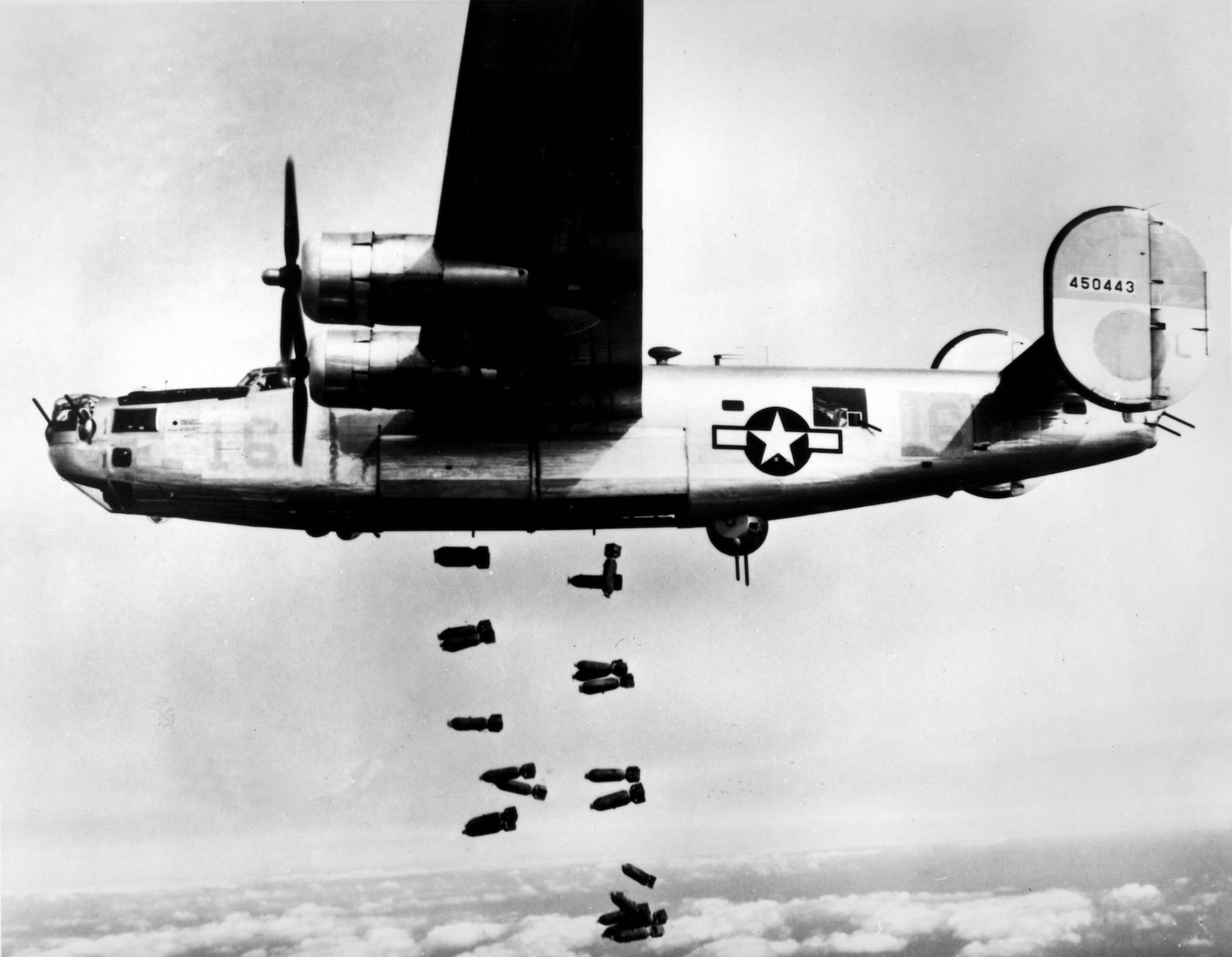 1940's -- A consolidated B-24 Liberator of the 15th A.F. releases its bombs on the railyards at Muhldorf, Germany on 19 March 1945.  Bombers of the 15th A.F. are slicing vital rail lines from Vienna to Munich as the air offensive against the enemy reaches an all time high. (U.S. Air Force photo)