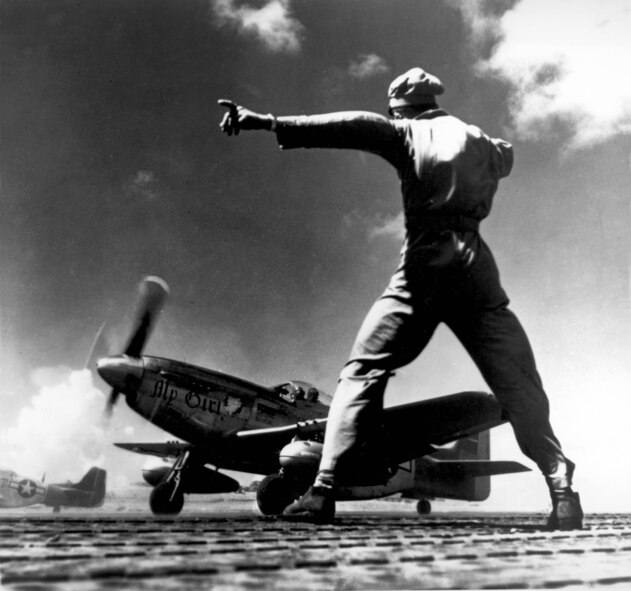 1940's -- A North American P-51 takes off from Iwo Jima, in the Bonin Islands.  From this hard-won base our fighters escorted the B-29s on bombing missions to Japan, and also attacked the Empire on their own.  (U.S. Air Force photo)