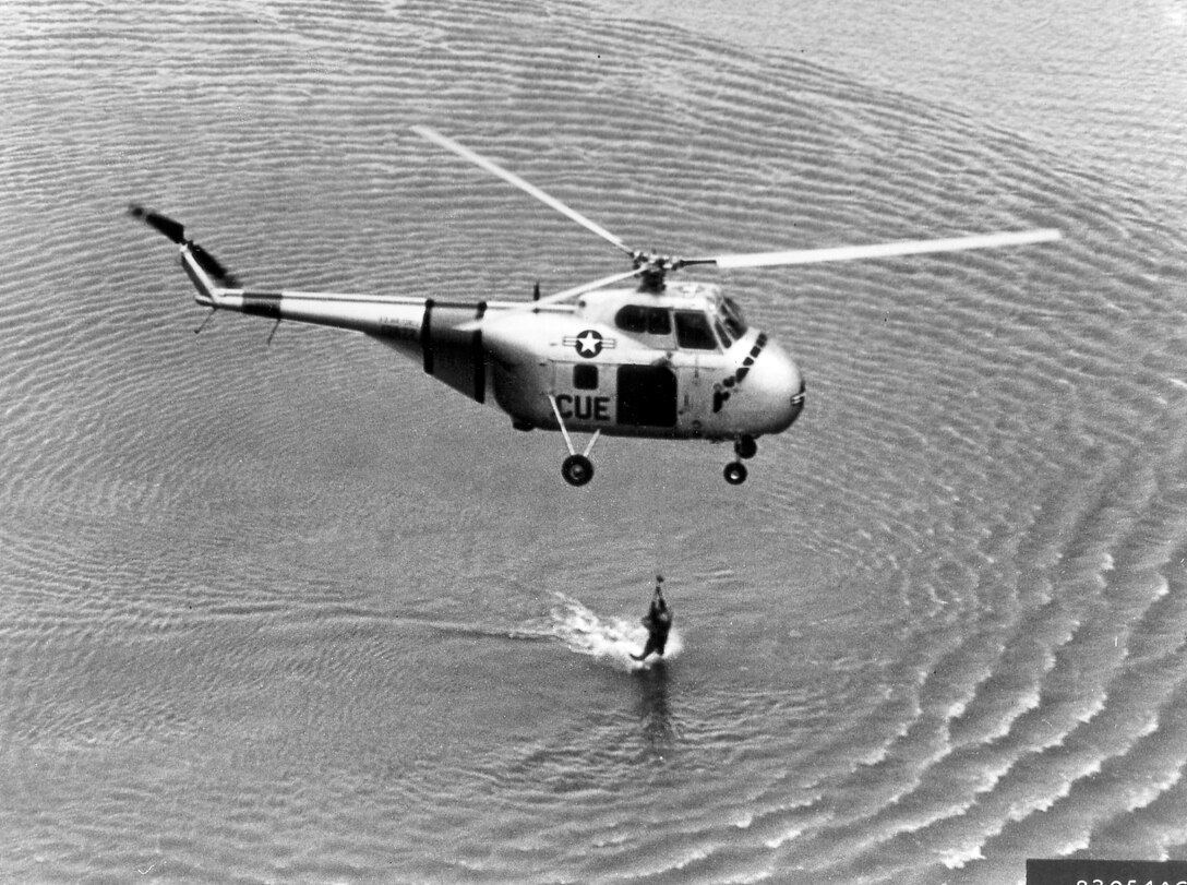 1950's -- A U.S.A.F. H-19 helicopter, 3rd Air Rescue Group, is seen hoisting an unidentified airman aboard from Far East waters.  1953 (U.S. Air Force photo)