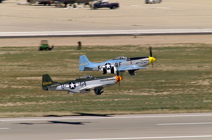 DAVIS-MONTHAN AIR FORCE BASE, Ariz. (AFPN) - Two P-51 Mustangs take off in formation during the Heritage Flight Conference held here recently.  The Heritage Flight Conference is designed to train and certify the Air Combat Command A-10 Thunderbolt II, F-15 Eagle and F-16 demonstration pilots to fly in formation with historical aircraft.  (U.S. Air Force photo by Staff Sgt. Jeremiah Erickson)