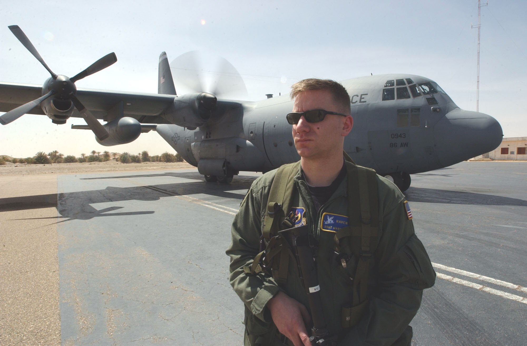 FAYA-LARGEAU AIRPORT, Chad (AFPN) -- Staff Sgt. Marc Hawsey stands watch here March 13 as 86th Airlift Wing crews deliver more than 19 tons of humanitarian aid.  Sergeant Hawsey is from the 786th Security Forces Squadron at Ramstein Air Base, Germany.  The aid was delivered in response to Chad's request for assistance after its military engaged a group of terrorists and sustained casualties. (U.S. Air Force photo by 1st Lt. Phillip Ulmer)


