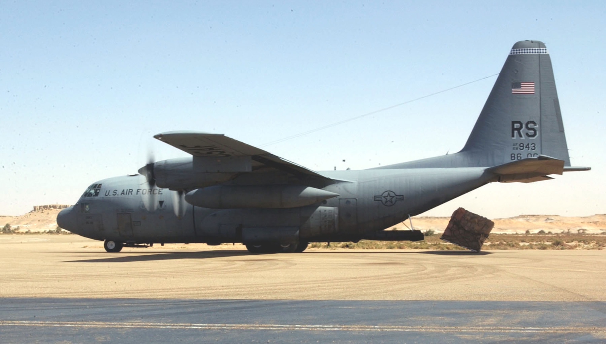 FAYA-LARGEAU AIRPORT, Chad (AFPN) -- A pallet of food and blankets slips off the back of an 86th Airlift Wing C-130 Hercules here March 13 as the crew performs a "combat offload." The aid was delivered in response to Chad's request for assistance after its military engaged a group of terrorists and sustained casualties.  (U.S. Air Force photo by 1st Lt. Phillip Ulmer)