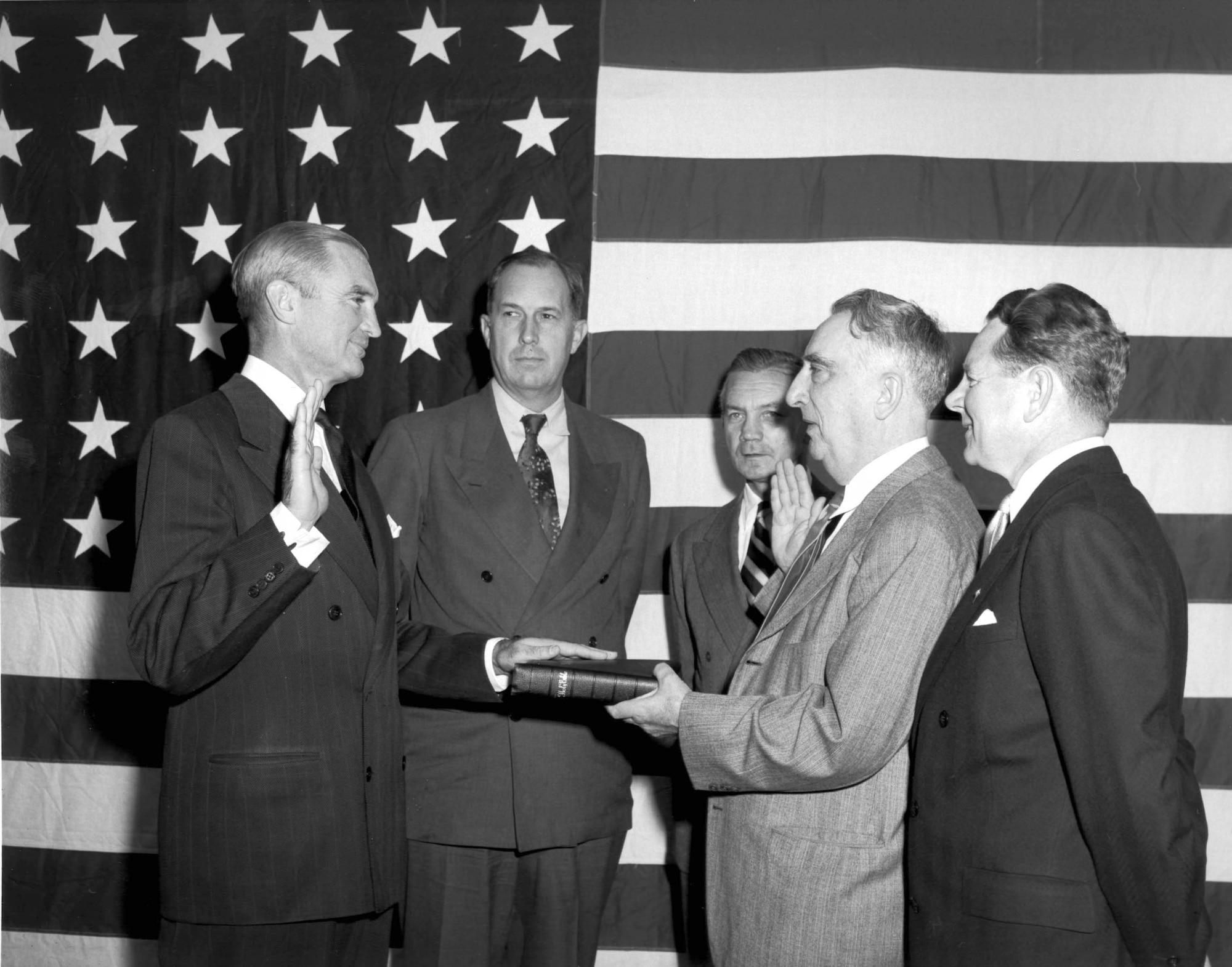 1940's -- W. Stuart Symington, former Assistant Secretary of War for Air, is shown taking the oath of office as Secretary of the Air Force from Chief Justice Fred Vincent.  Left to right are: Secretary Symington, Secretary of the Army, Kenneth C. Royall, Secretary of National Defense James N. Forrestal, Chief Justice Vincent and Secretary of the Navy John Sullivan. (U.S. Air Force photo)