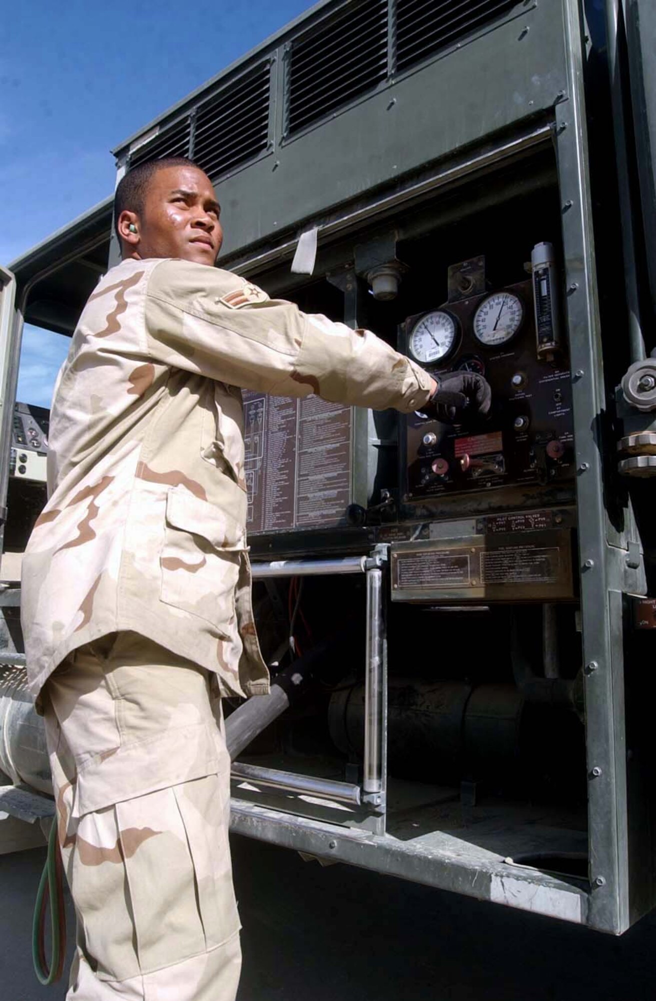 BAGRAM AIR BASE, Afghanistan -- Airman 1st Class Omar Foster adjusts the throttle of an R-11 refueler during an A-10 Thunderbolt II refueling operation.  Airman is assigned to the 455th Expeditionary Operations Group fuels flight, and he is deployed from Hurlburt Field, Fla.  (U.S. Air Force photo by Master Sgt. Jeff Szczechowski)